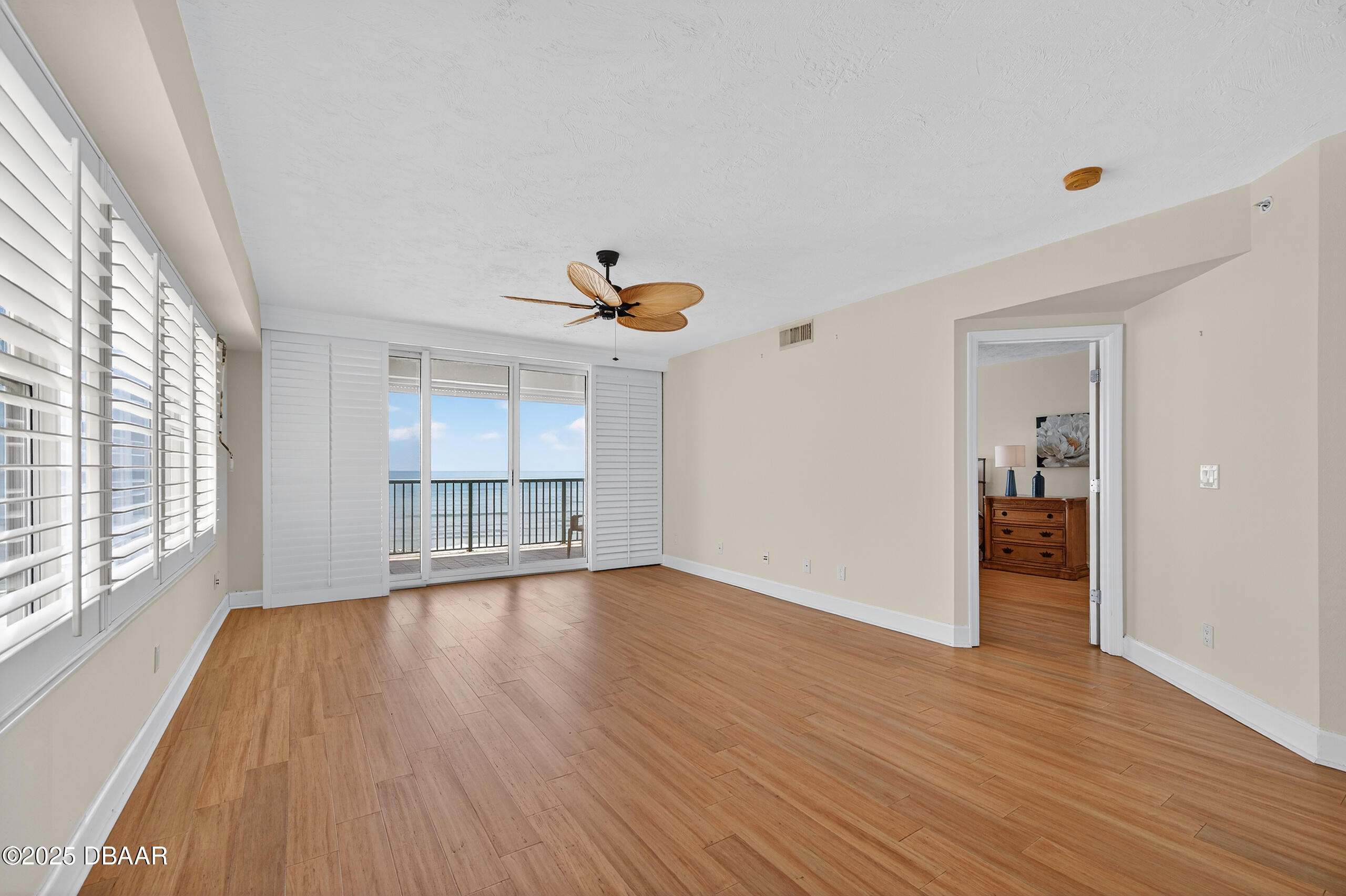 4555 South Atlantic Avenue, Unit 4603 Ponce Inlet, FL 32127 - Photo 25 of 39 a view of empty room with wooden floor and fan