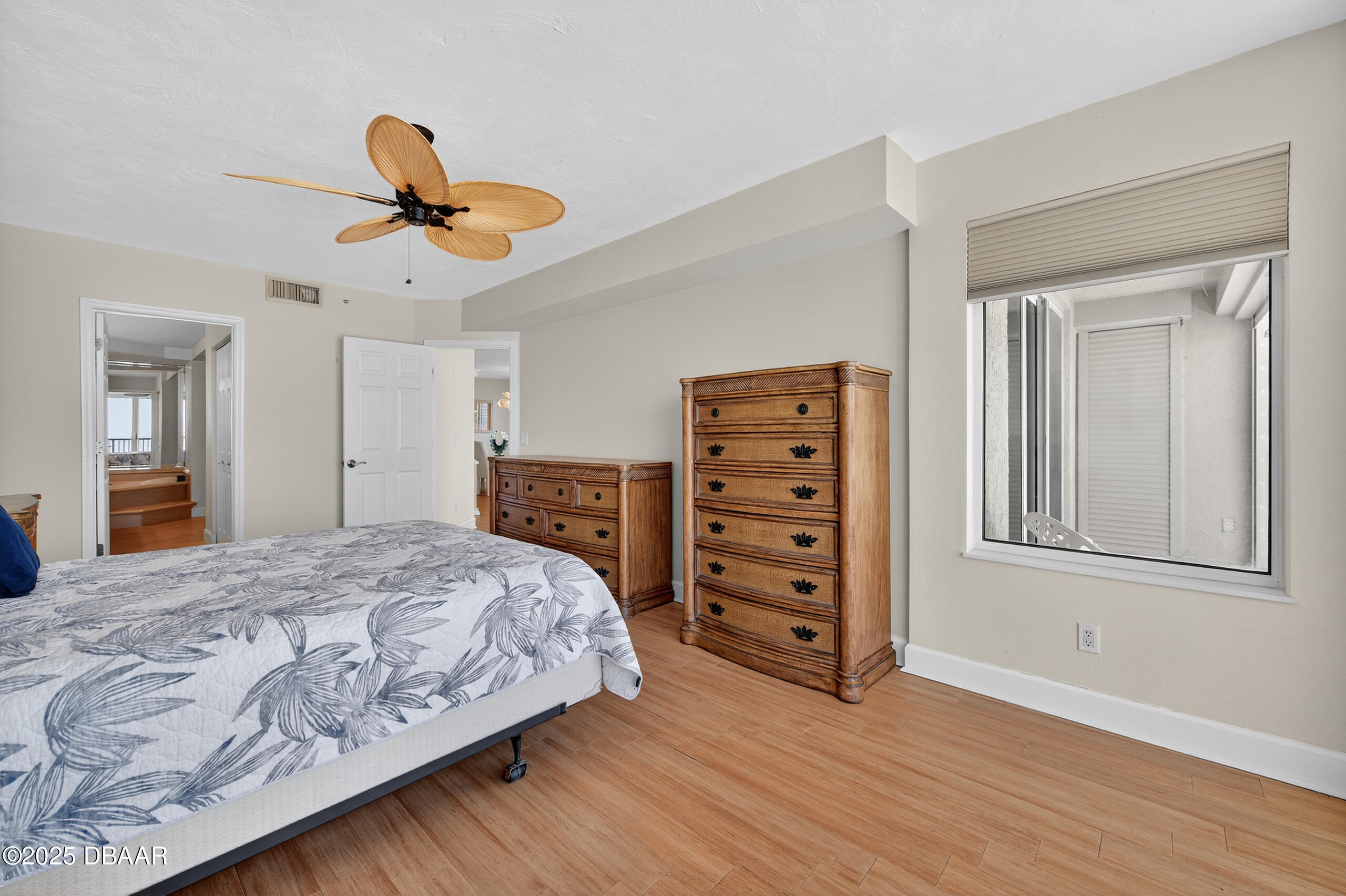4555 South Atlantic Avenue, Unit 4603 Ponce Inlet, FL 32127 - Photo 28 of 39 a bedroom with a bed and wooden floor