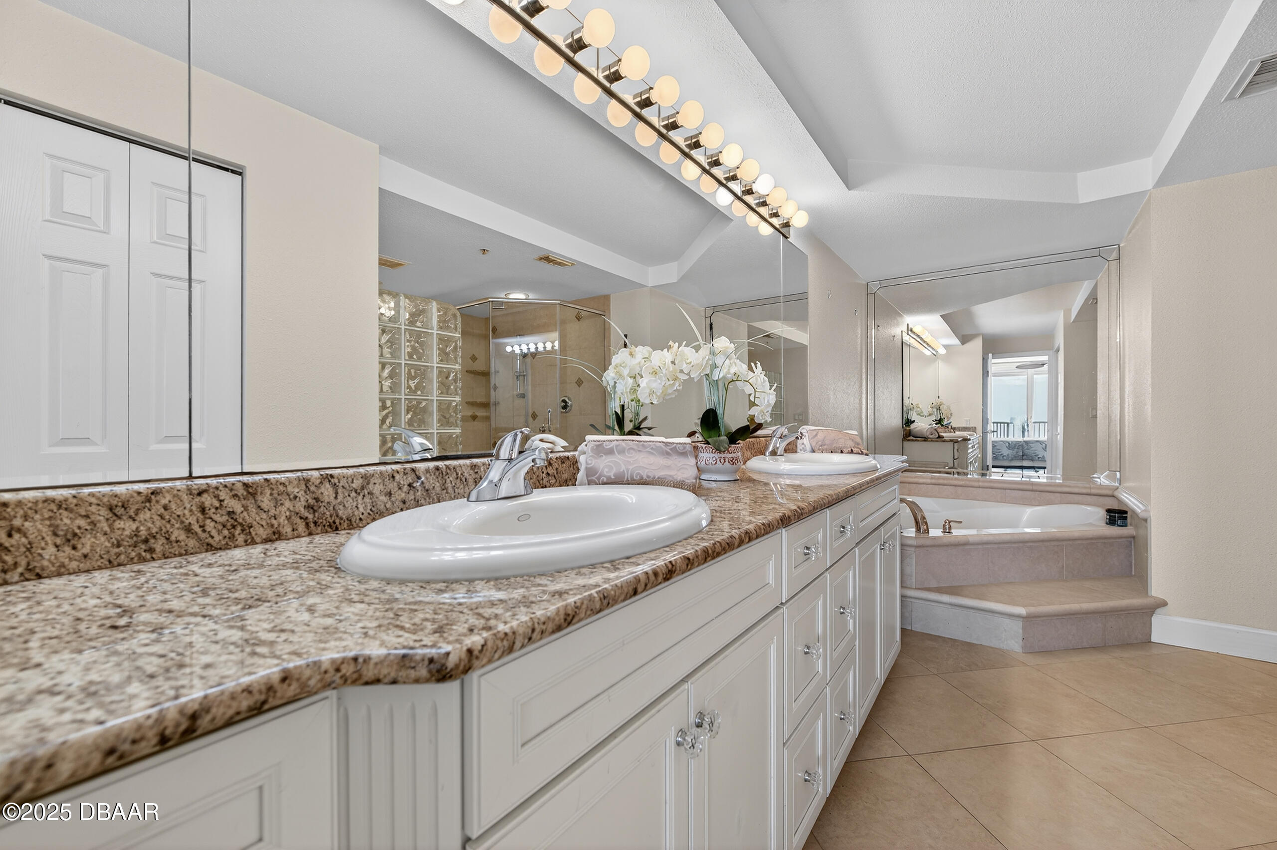 4555 South Atlantic Avenue, Unit 4603 Ponce Inlet, FL 32127 - Photo 29 of 39 a bathroom with a granite countertop sink a mirror and a bathtub