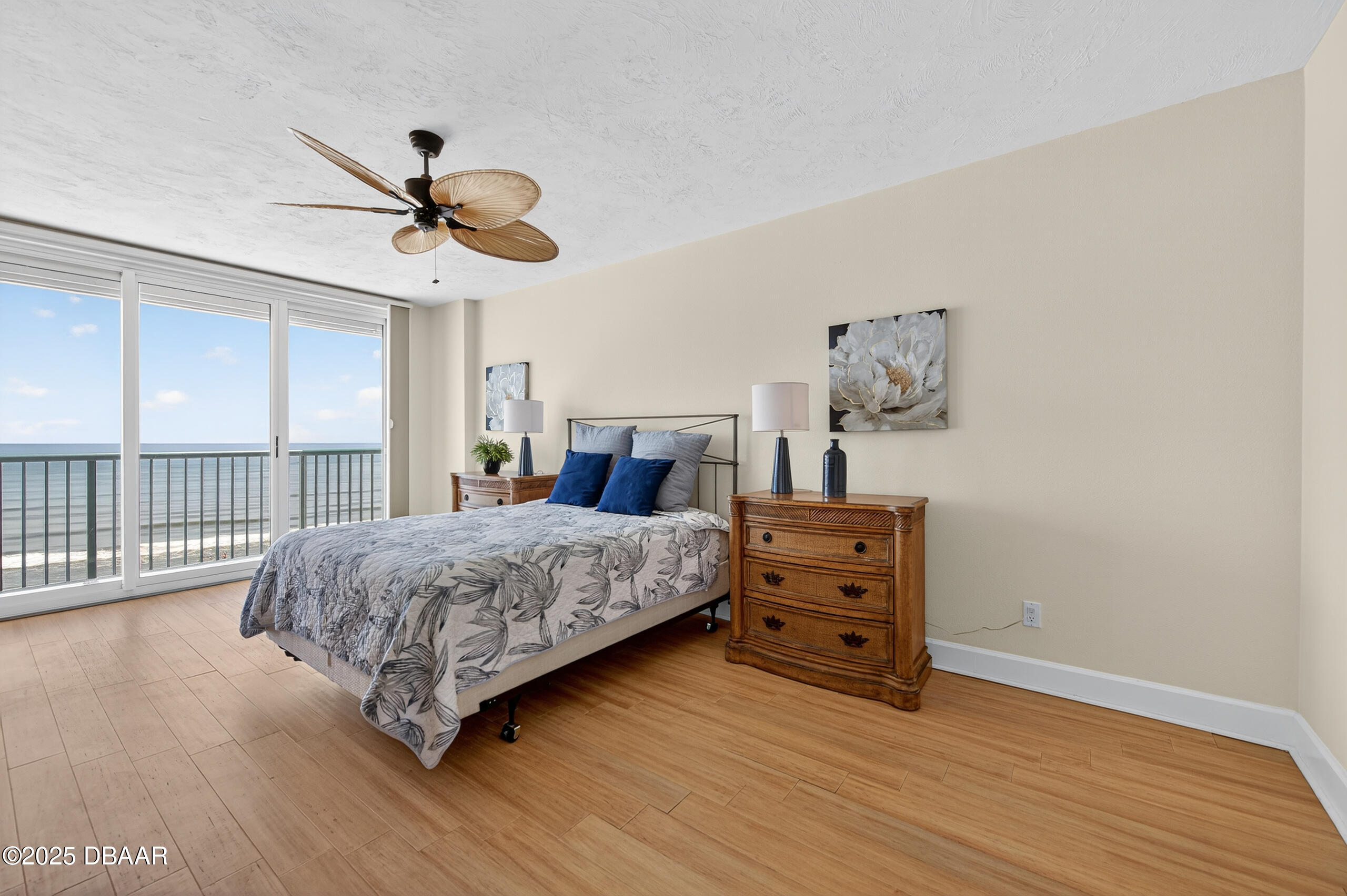 4555 South Atlantic Avenue, Unit 4603 Ponce Inlet, FL 32127 - Photo 3 of 39 a bedroom with a bed and wooden floor