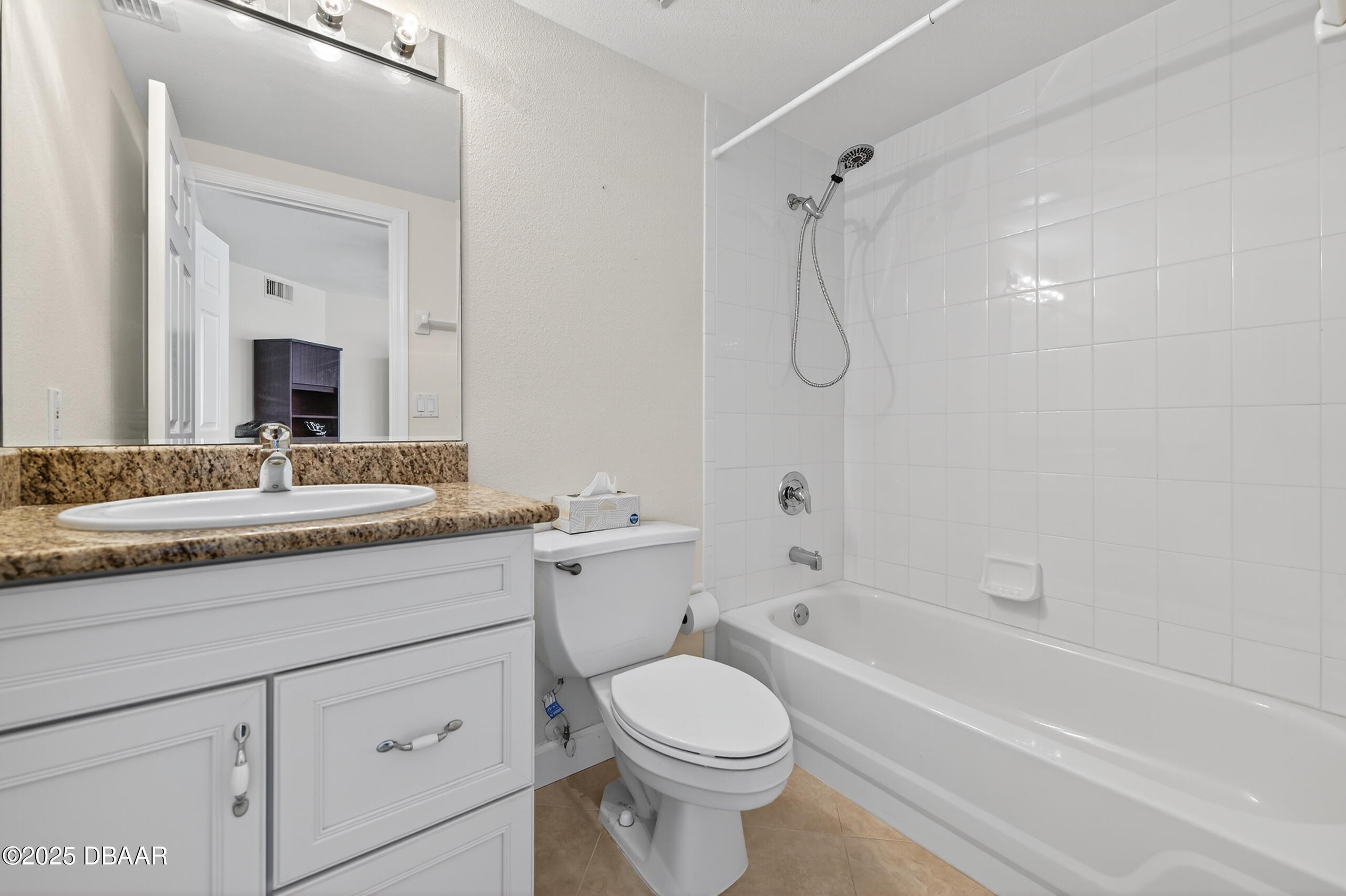 4555 South Atlantic Avenue, Unit 4603 Ponce Inlet, FL 32127 - Photo 34 of 39 a bathroom with a granite countertop sink a toilet and a bathtub