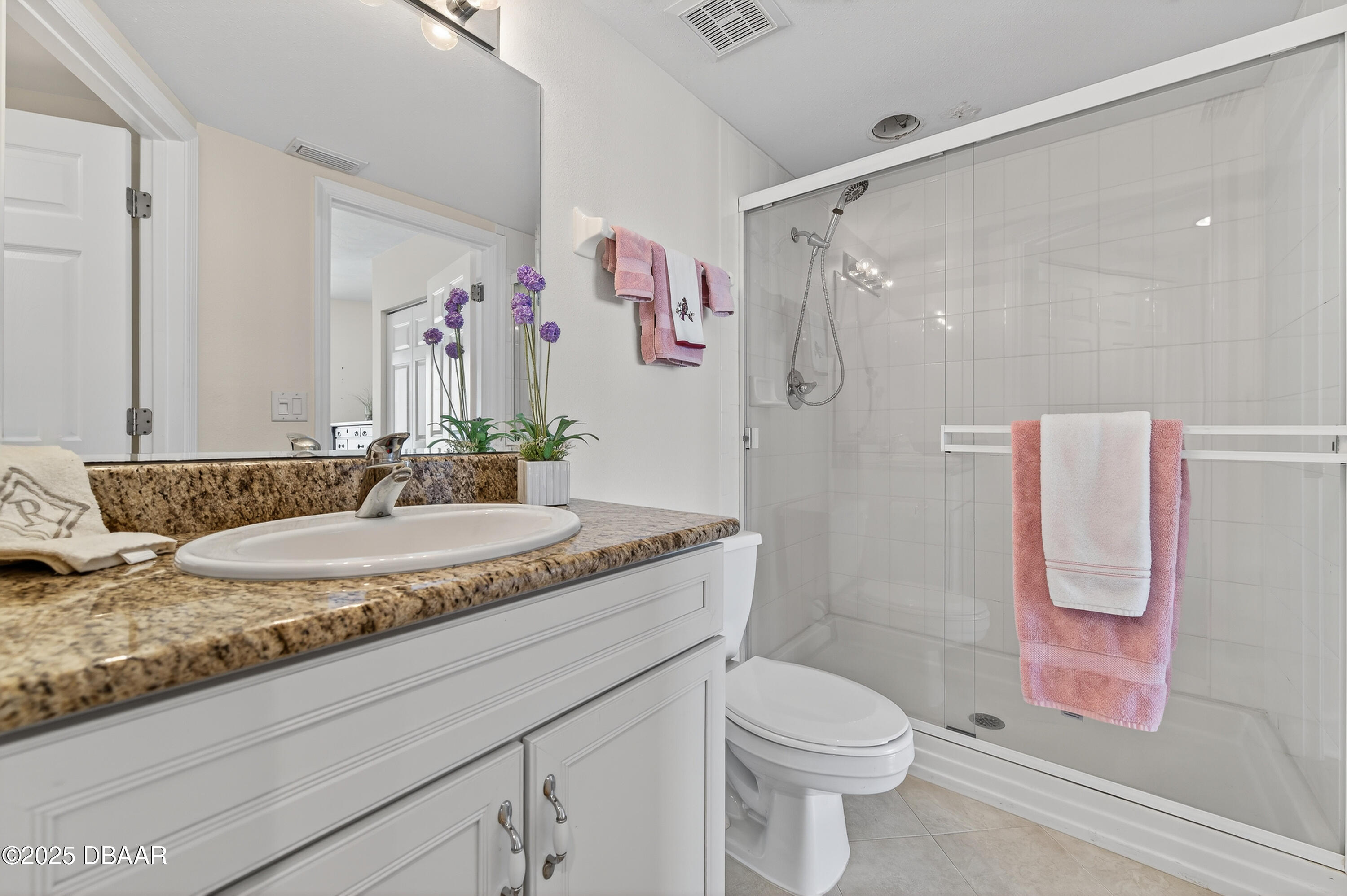 4555 South Atlantic Avenue, Unit 4603 Ponce Inlet, FL 32127 - Photo 35 of 39 a bathroom with a granite countertop sink toilet and shower