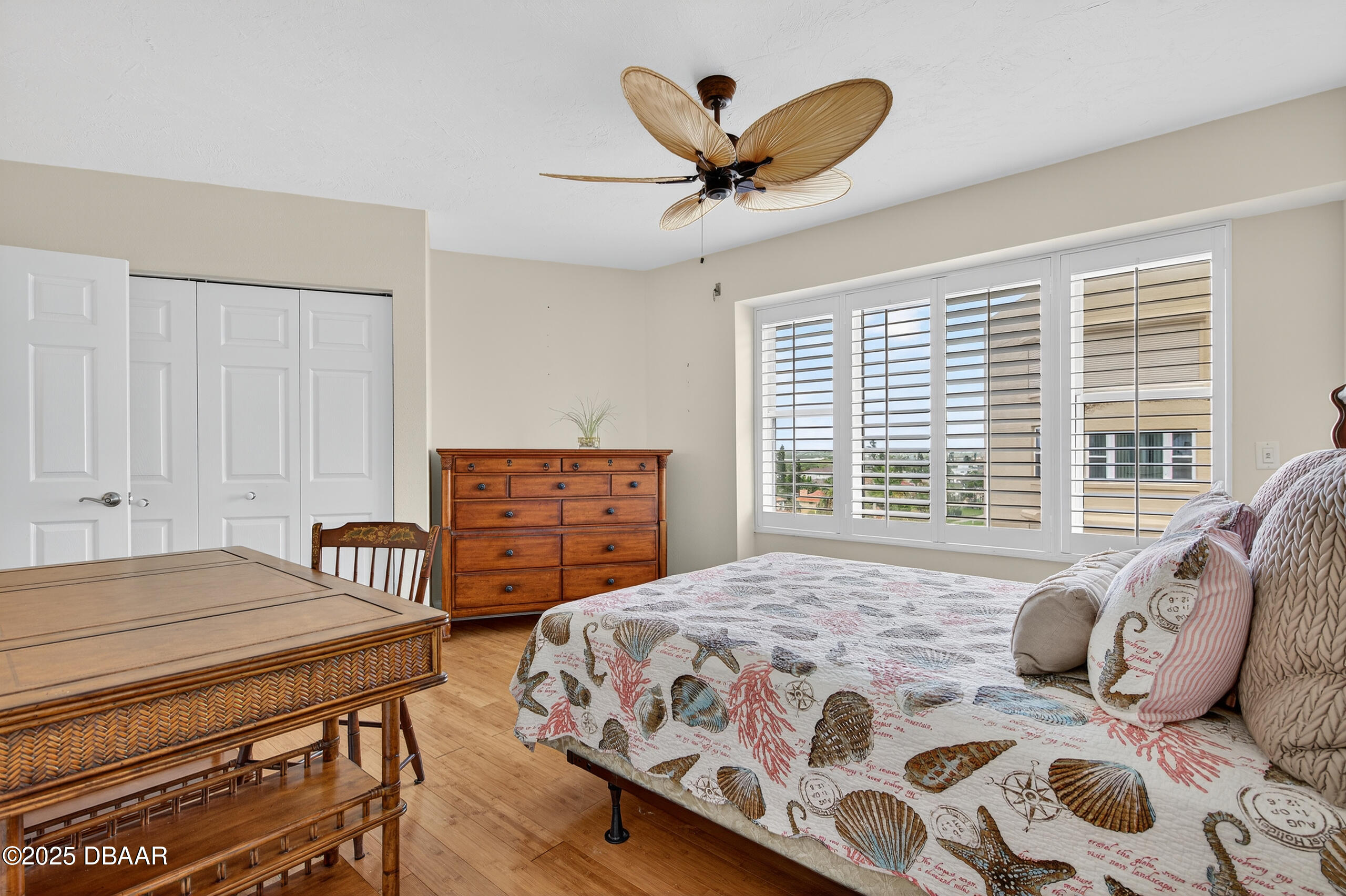 4555 South Atlantic Avenue, Unit 4603 Ponce Inlet, FL 32127 - Photo 37 of 39 a bedroom with a bed and a chandelier