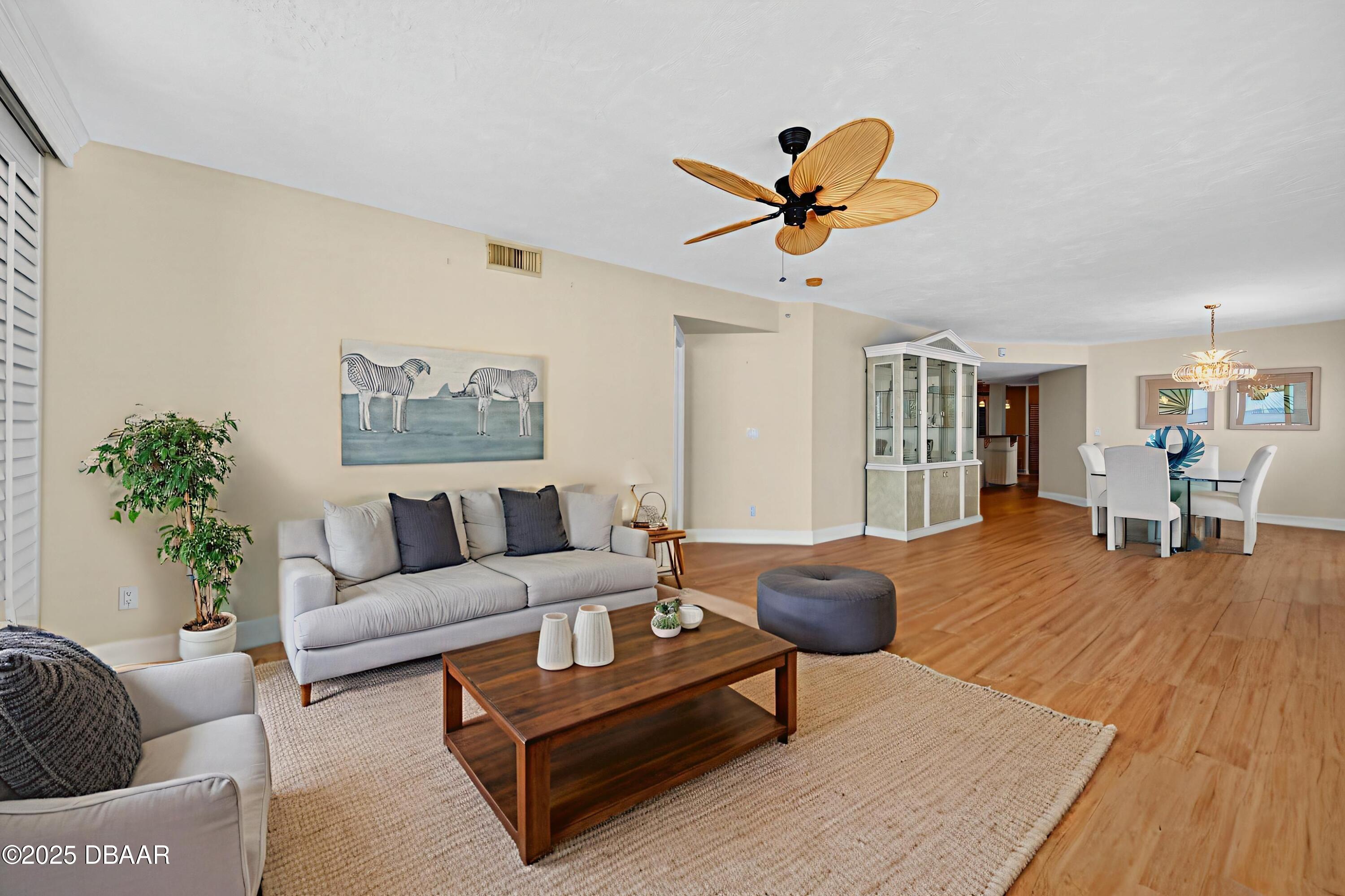 4555 South Atlantic Avenue, Unit 4603 Ponce Inlet, FL 32127 - Photo 5 of 39 a living room with furniture and a wooden floor