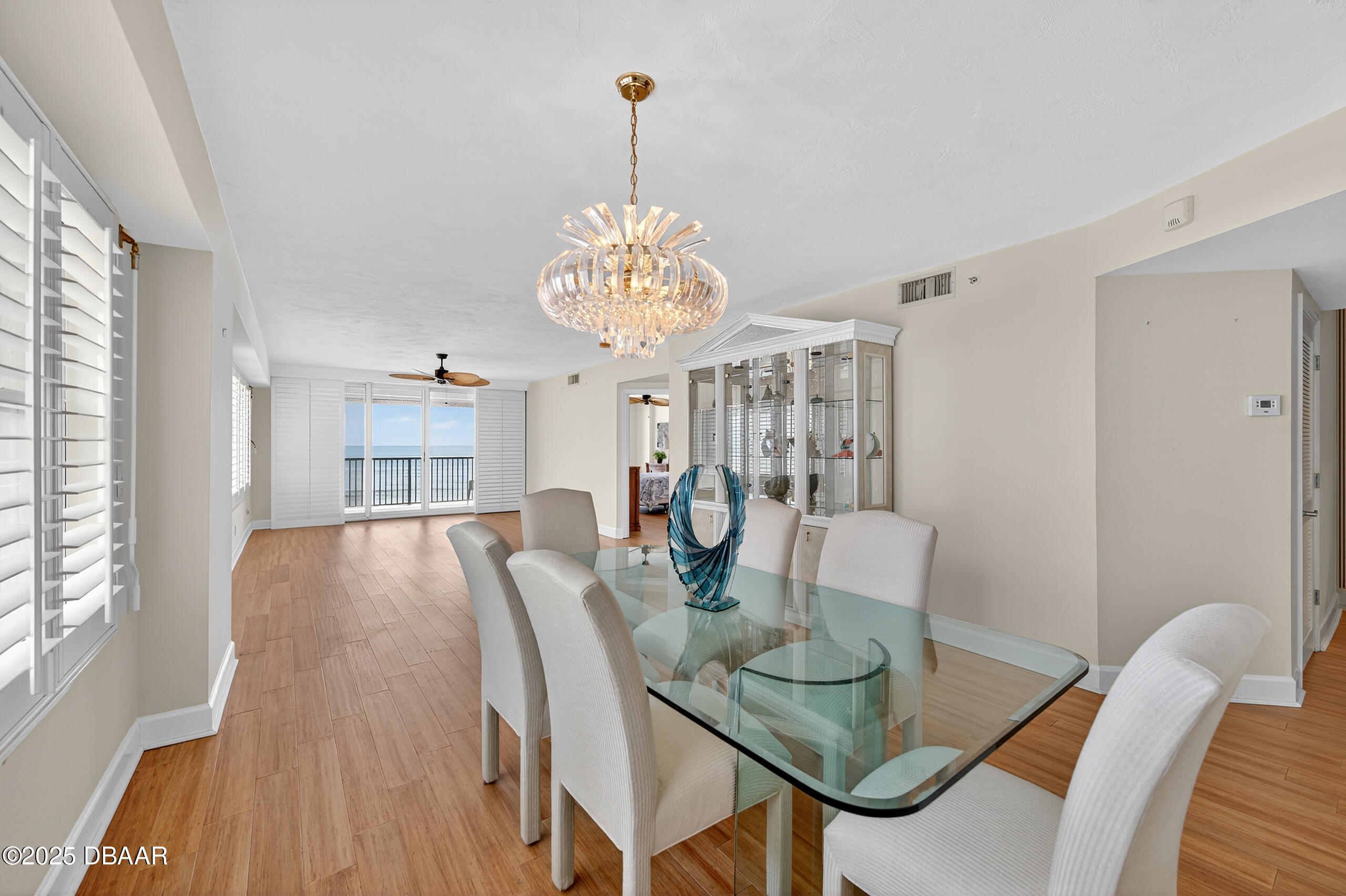 4555 South Atlantic Avenue, Unit 4603 Ponce Inlet, FL 32127 - Photo 8 of 39 a view of a dining room with furniture a chandelier and wooden floor