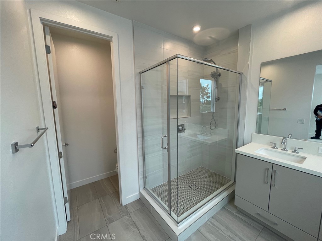 691 South Lyon Street Santa Ana, CA 92705 - Photo 15 of 17 a bathroom with a shower a sink and a mirror