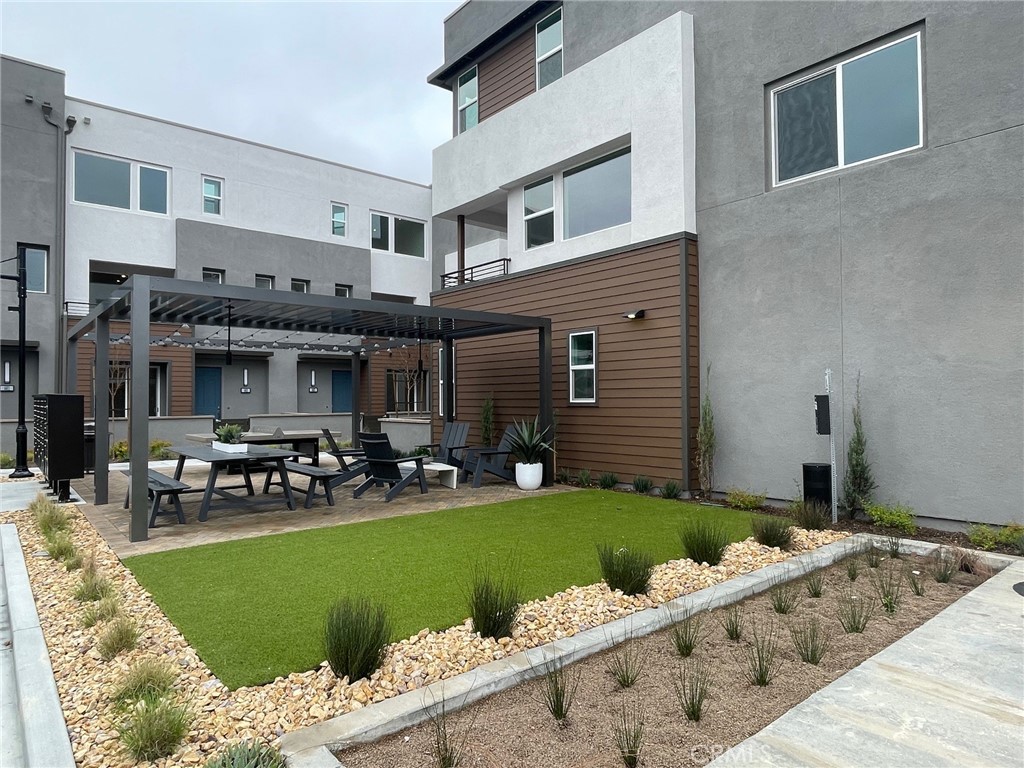691 South Lyon Street Santa Ana, CA 92705 - Photo 2 of 17 a front view of a house with a garden and patio
