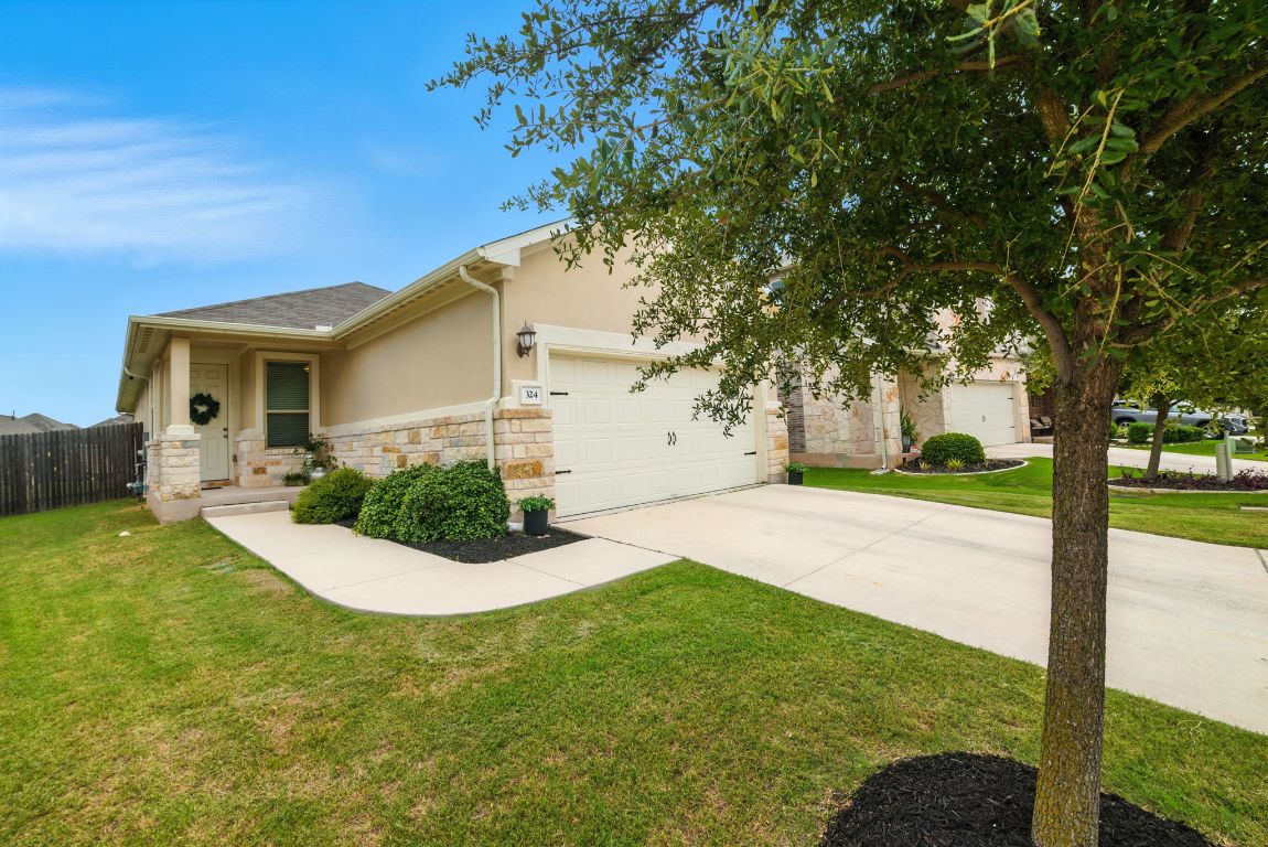 324 Mountain Valley Street Georgetown, TX 78628 - Photo 1 of 1 a view of a house with backyard and a tree