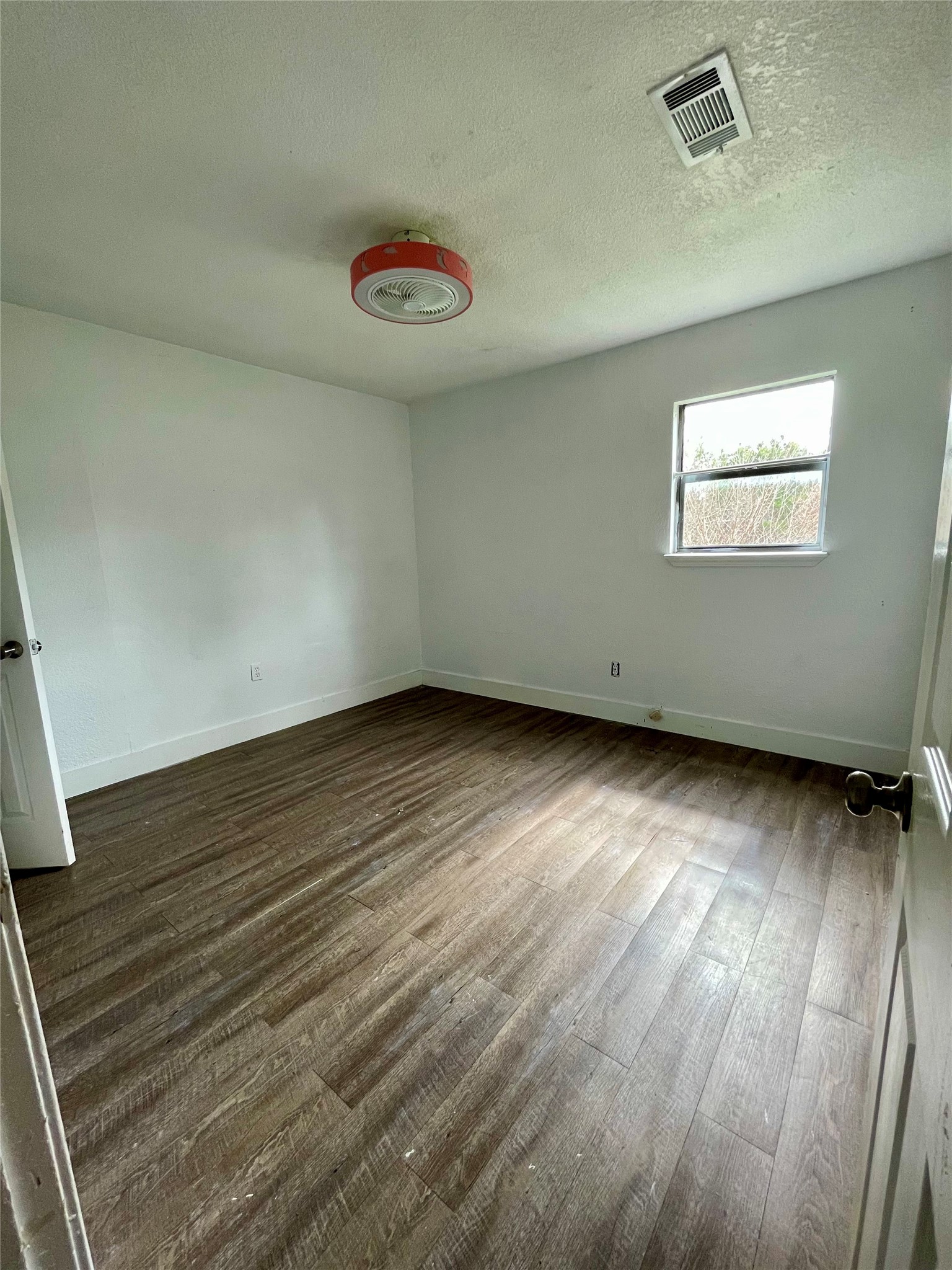 893 County Road 3376 Kempner, TX 76539 - Photo 14 of 23 an empty room with wooden floor and windows