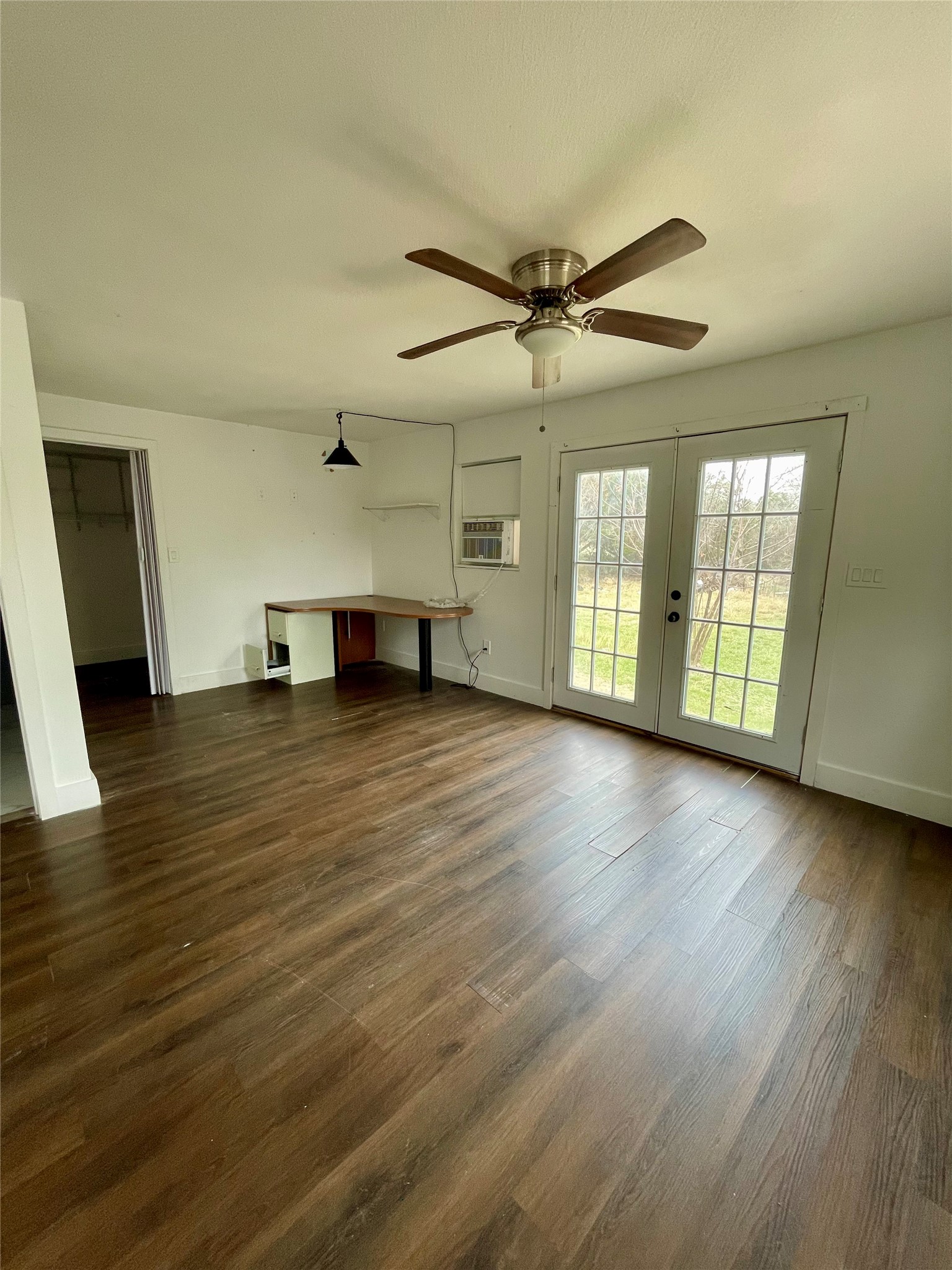 893 County Road 3376 Kempner, TX 76539 - Photo 2 of 23 a view of an empty room with wooden floor and a window