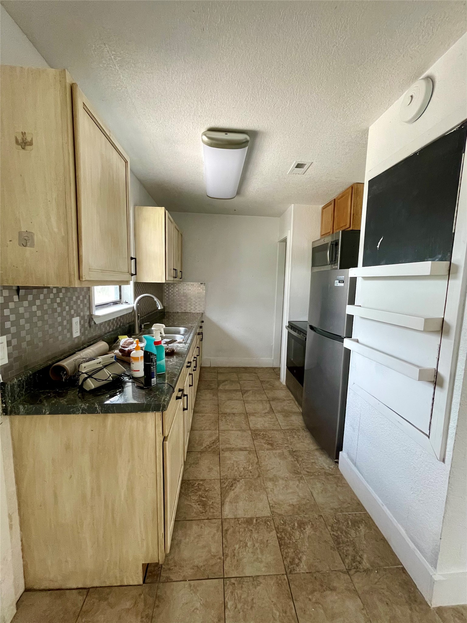 893 County Road 3376 Kempner, TX 76539 - Photo 7 of 23 a kitchen with a sink and a refrigerator