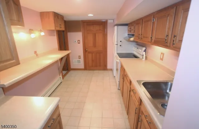 a kitchen with a sink a stove and a refrigerator
