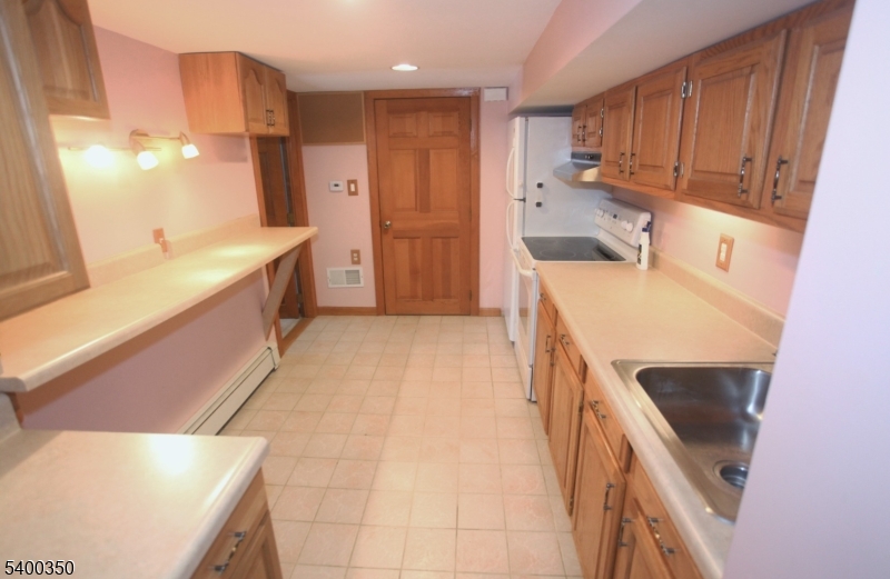 22 Choctaw Oak Ridge Oak Ridge, NJ 07438 - Photo 15 of 23 a kitchen with a sink a stove and a refrigerator