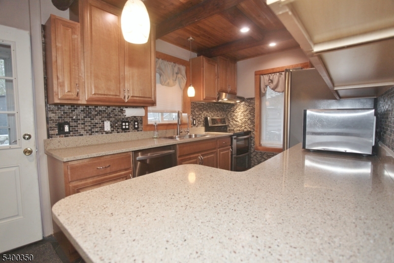 22 Choctaw Oak Ridge Oak Ridge, NJ 07438 - Photo 4 of 23 a kitchen with stainless steel appliances a sink and a refrigerator
