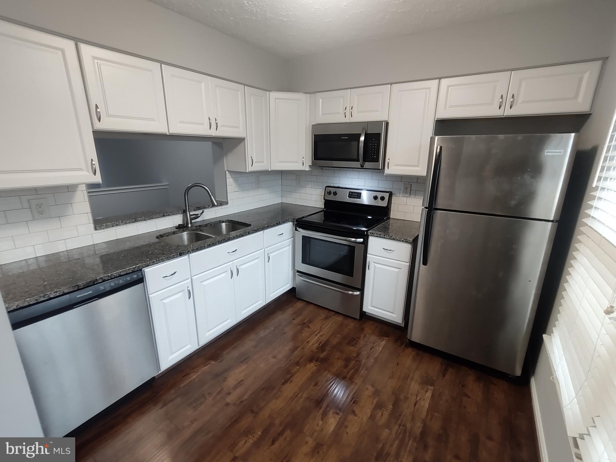 11235 Kettering Place Upper Marlboro, MD 20774 - Photo 18 of 22 a kitchen with a sink a refrigerator and cabinets