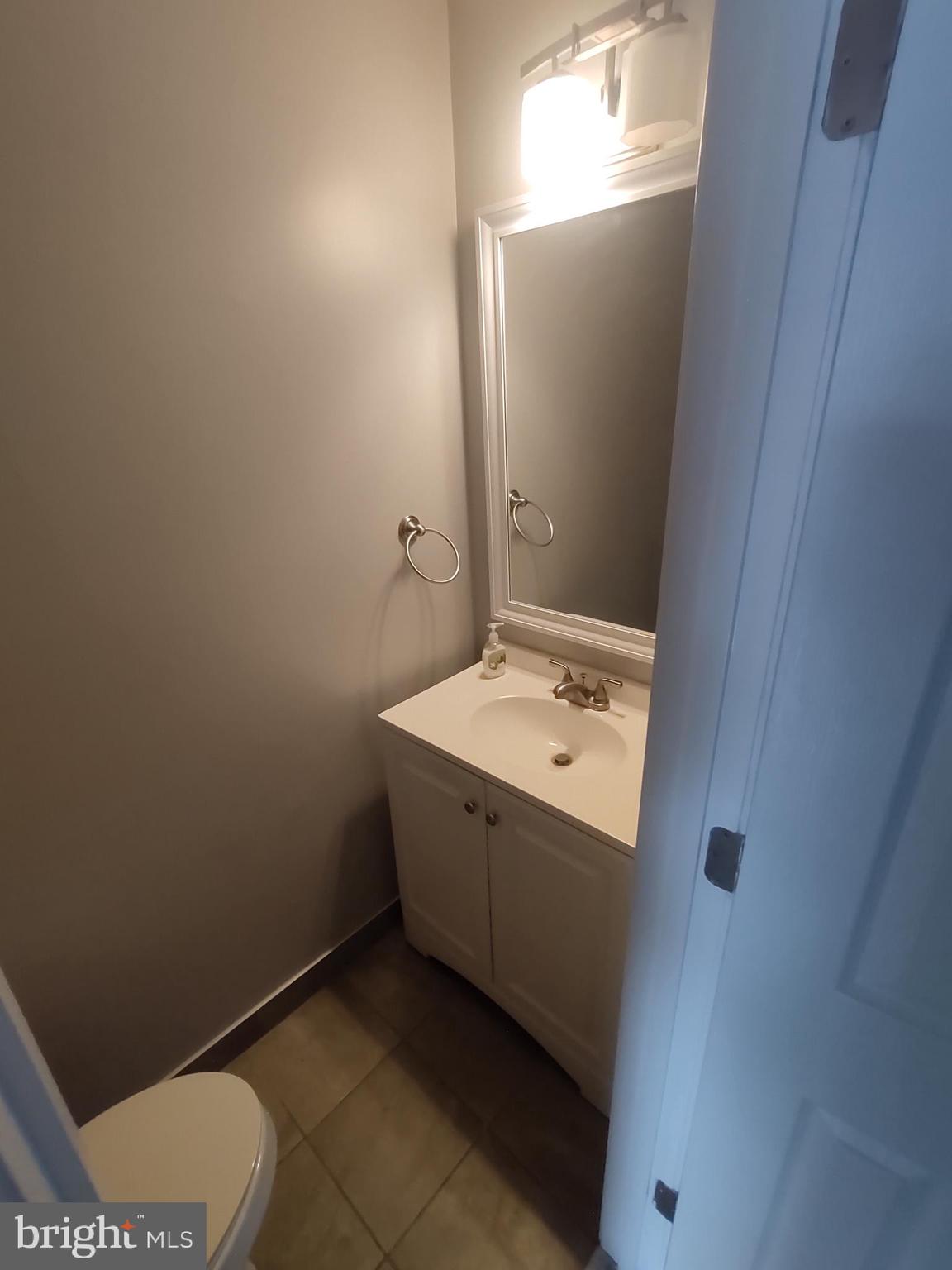 11235 Kettering Place Upper Marlboro, MD 20774 - Photo 21 of 22 a utility room with a sink a toilet and a window