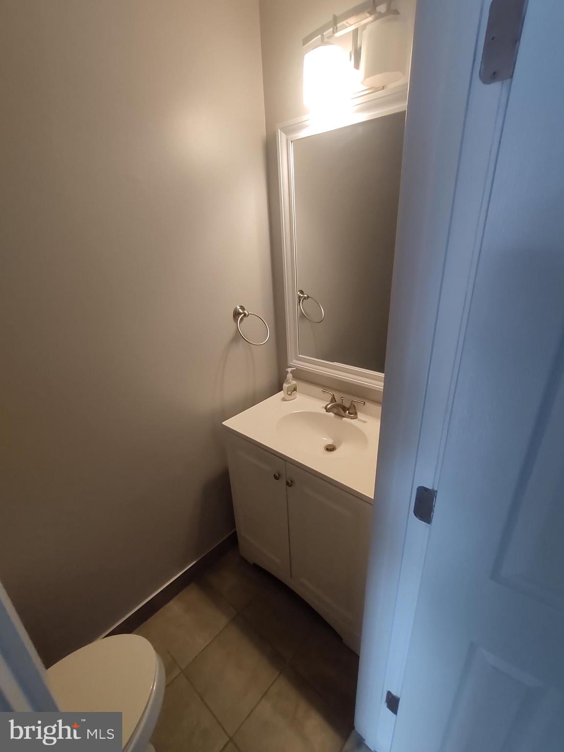 11235 Kettering Place Upper Marlboro, MD 20774 - Photo 22 of 22 a view of bathroom with a toilet sink and mirror