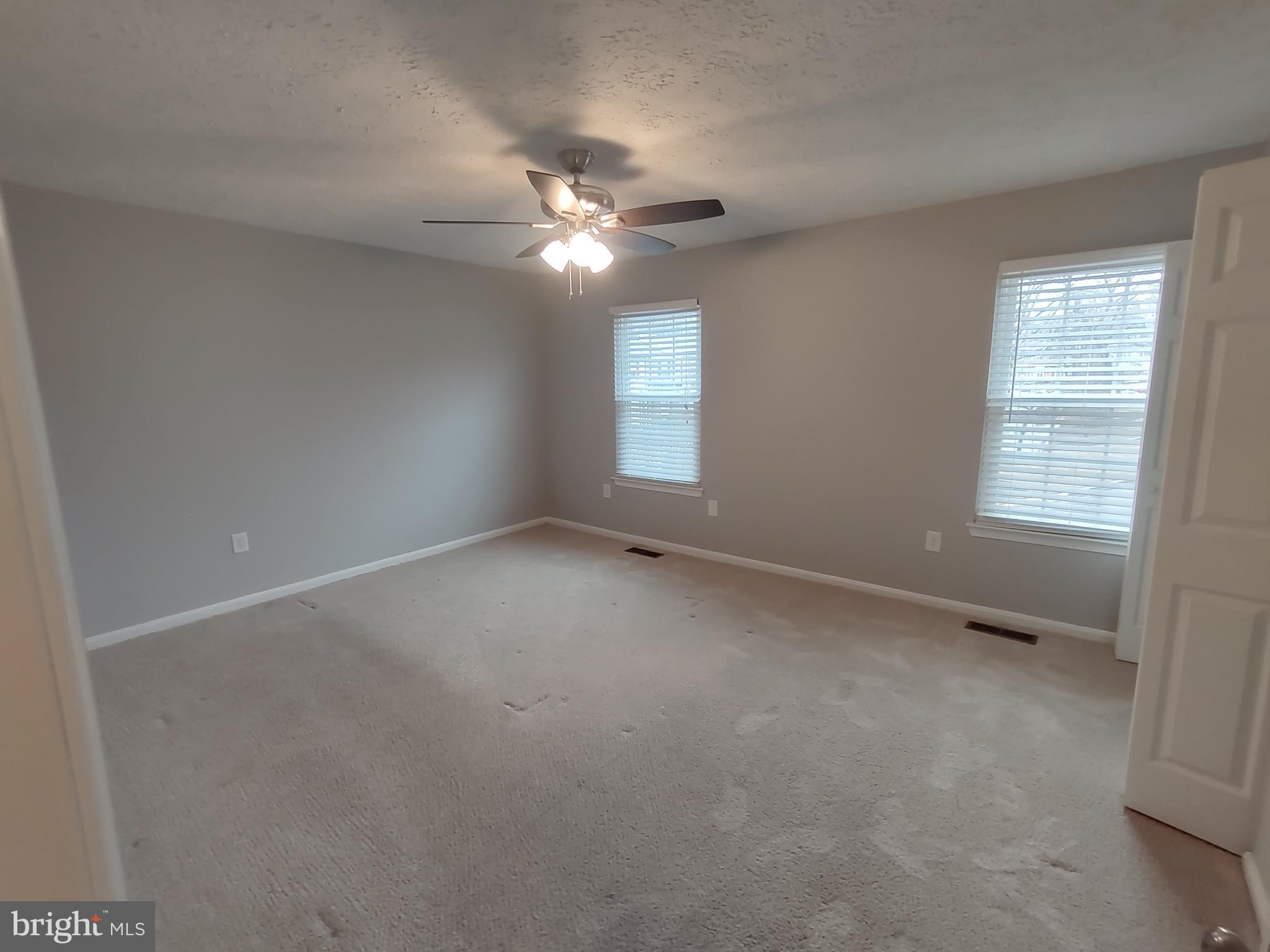 11235 Kettering Place Upper Marlboro, MD 20774 - Photo 5 of 22 an empty room with a window and a fan