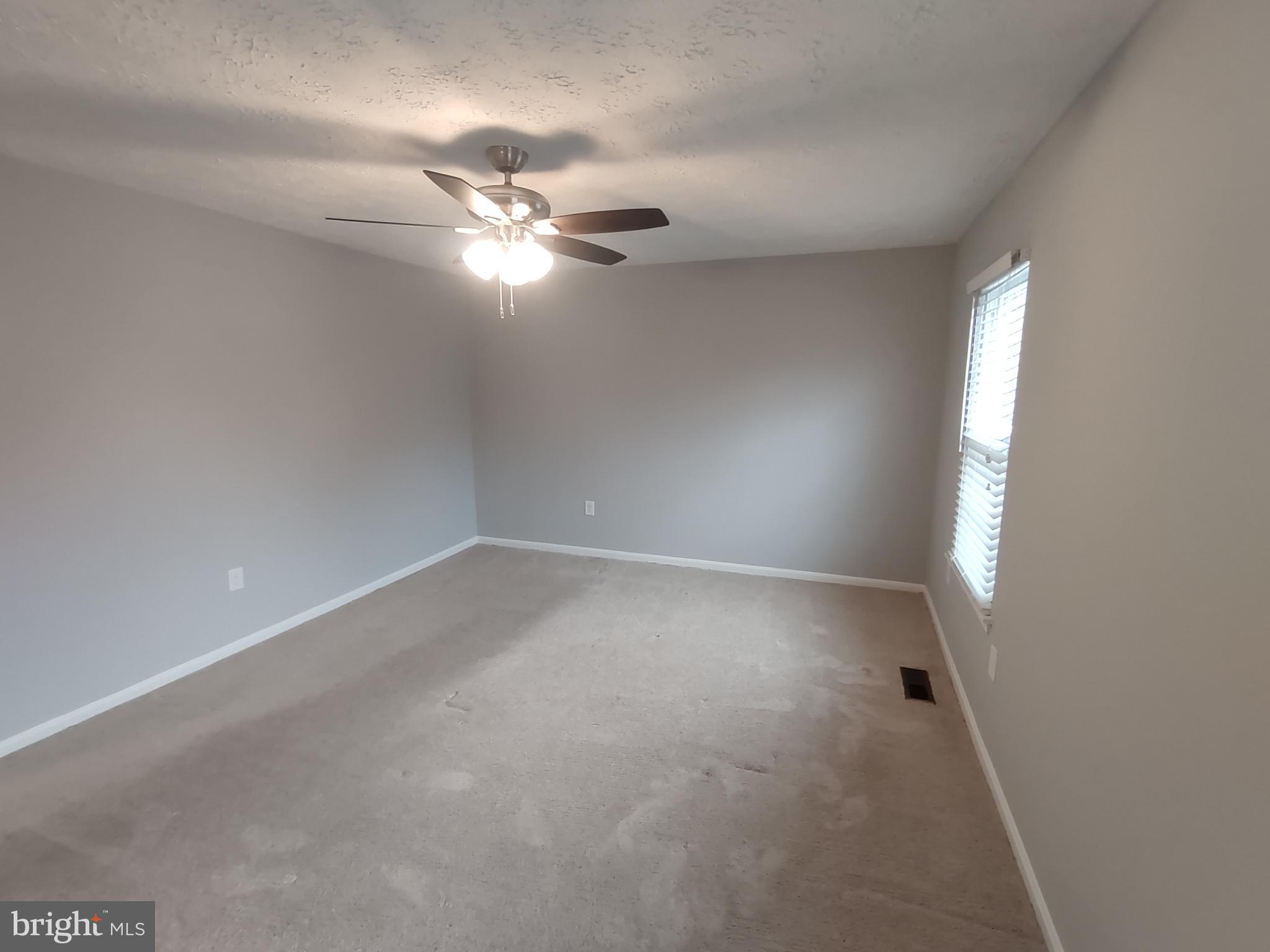 11235 Kettering Place Upper Marlboro, MD 20774 - Photo 7 of 22 en empty room with windows and fan