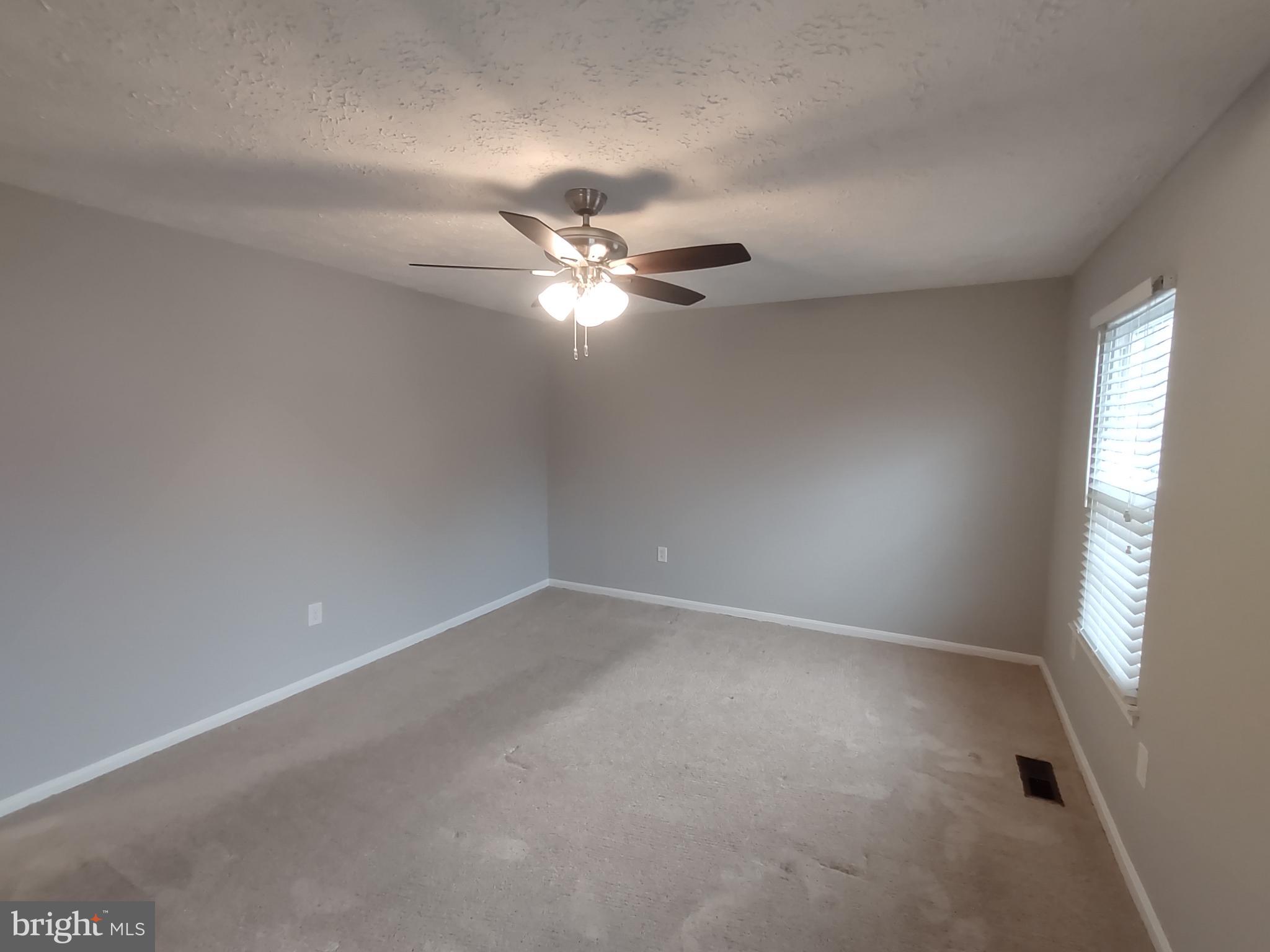 11235 Kettering Place Upper Marlboro, MD 20774 - Photo 8 of 22 an empty room with fan and windows