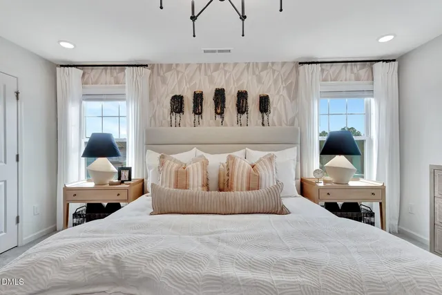 a bedroom with a bed and a chandelier