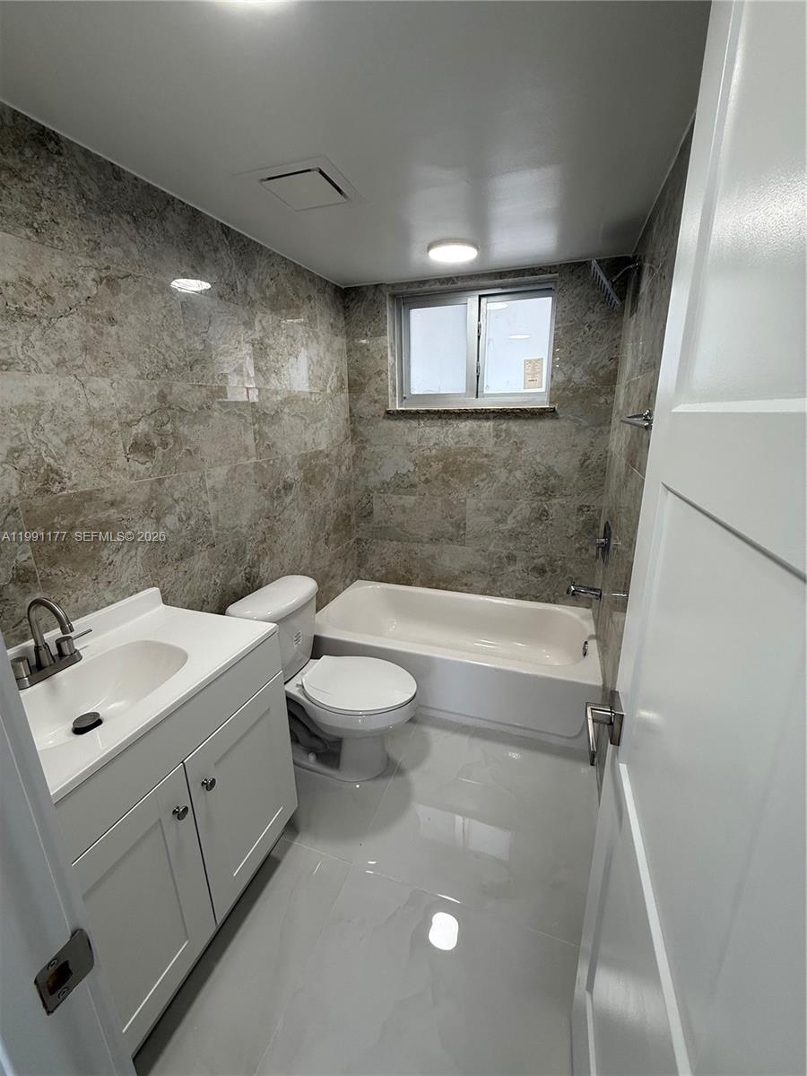 9915 West Okeechobee Road, Unit 2201 Hialeah Gardens, FL 33016 - Photo 11 of 11 a bathroom with a sink a toilet and shower