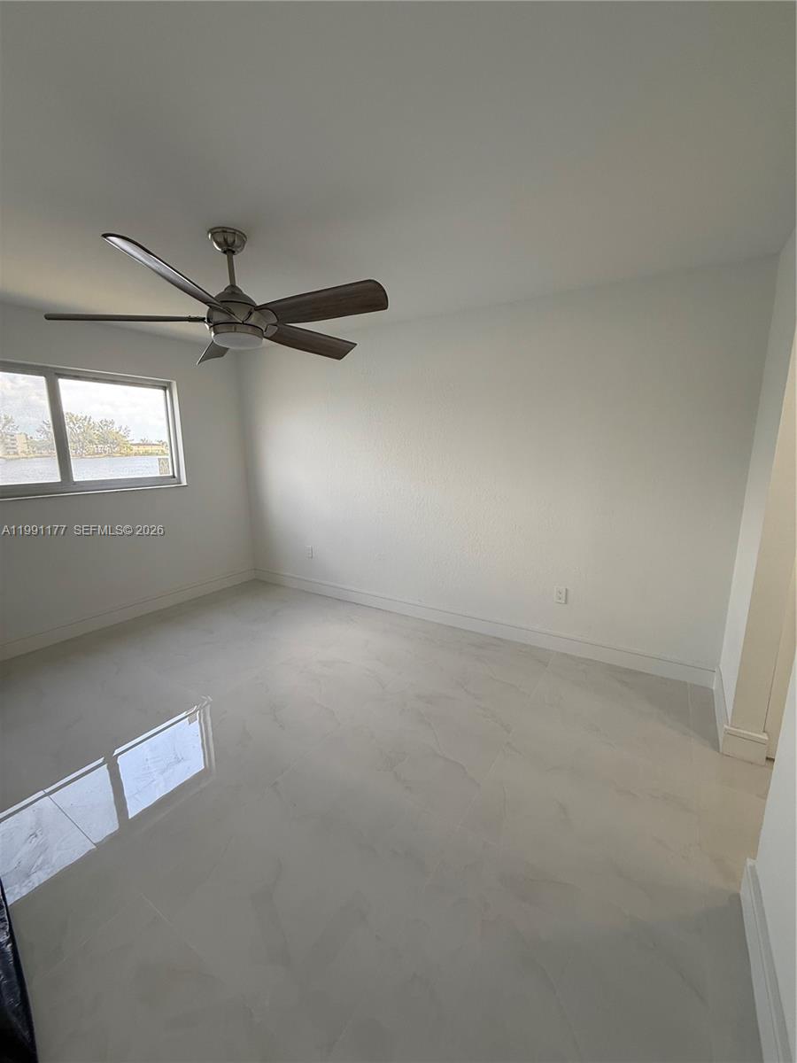 9915 West Okeechobee Road, Unit 2201 Hialeah Gardens, FL 33016 - Photo 5 of 11 an empty room with a window