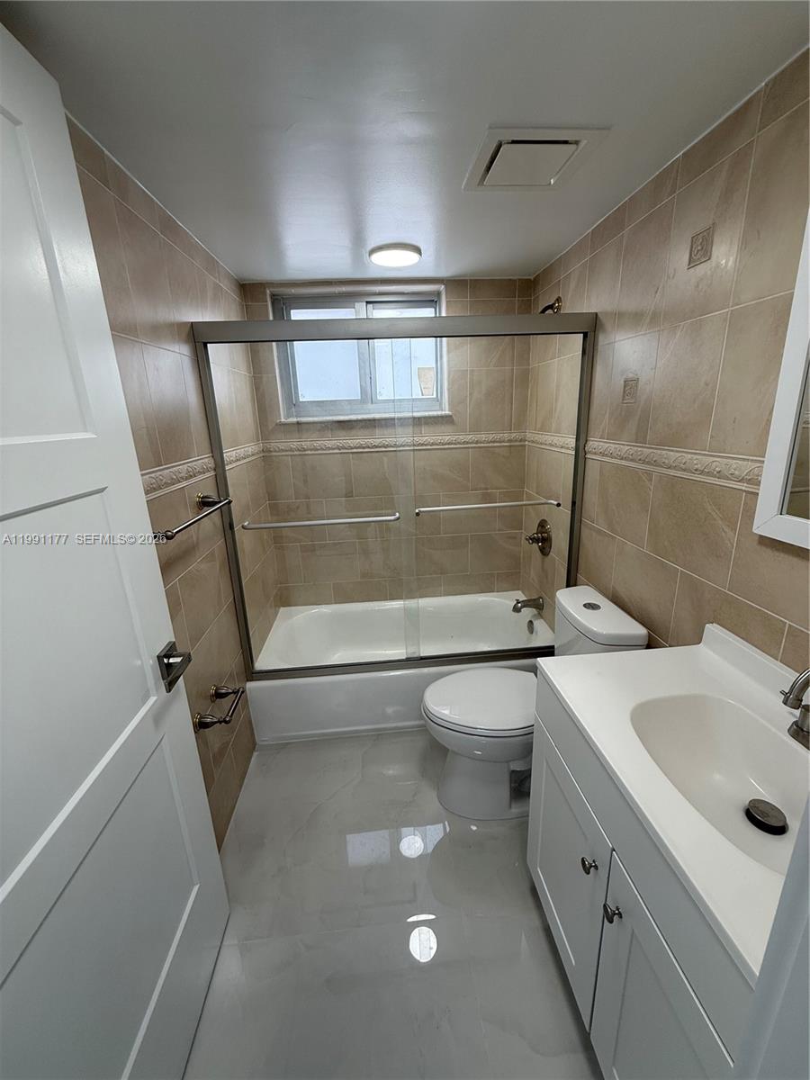 9915 West Okeechobee Road, Unit 2201 Hialeah Gardens, FL 33016 - Photo 6 of 11 a bathroom with a sink a toilet and shower