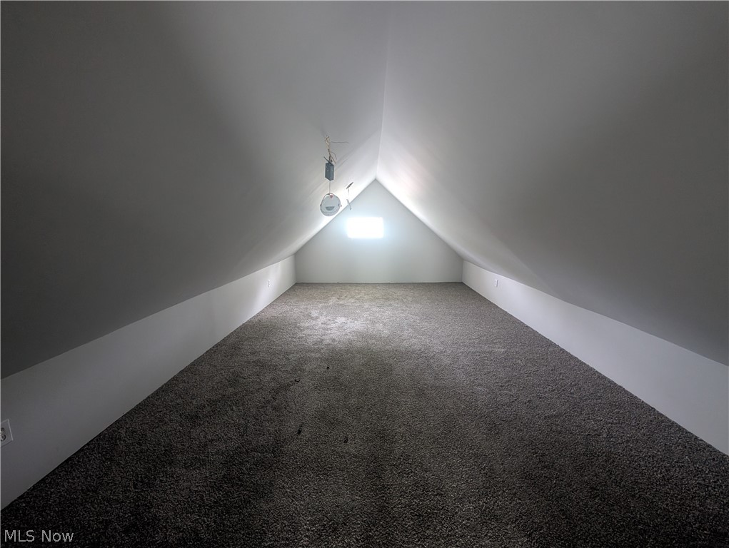 7515 Ottawa Road Cleveland, OH 44105 - Photo 12 of 21 Finished attic space featuring sloped ceilings, a single window, and neutral-toned carpeting