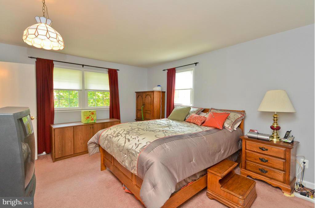 5319 Moultrie Road Springfield, VA 22151 - Photo 14 of 30 a bedroom with a bed and a window