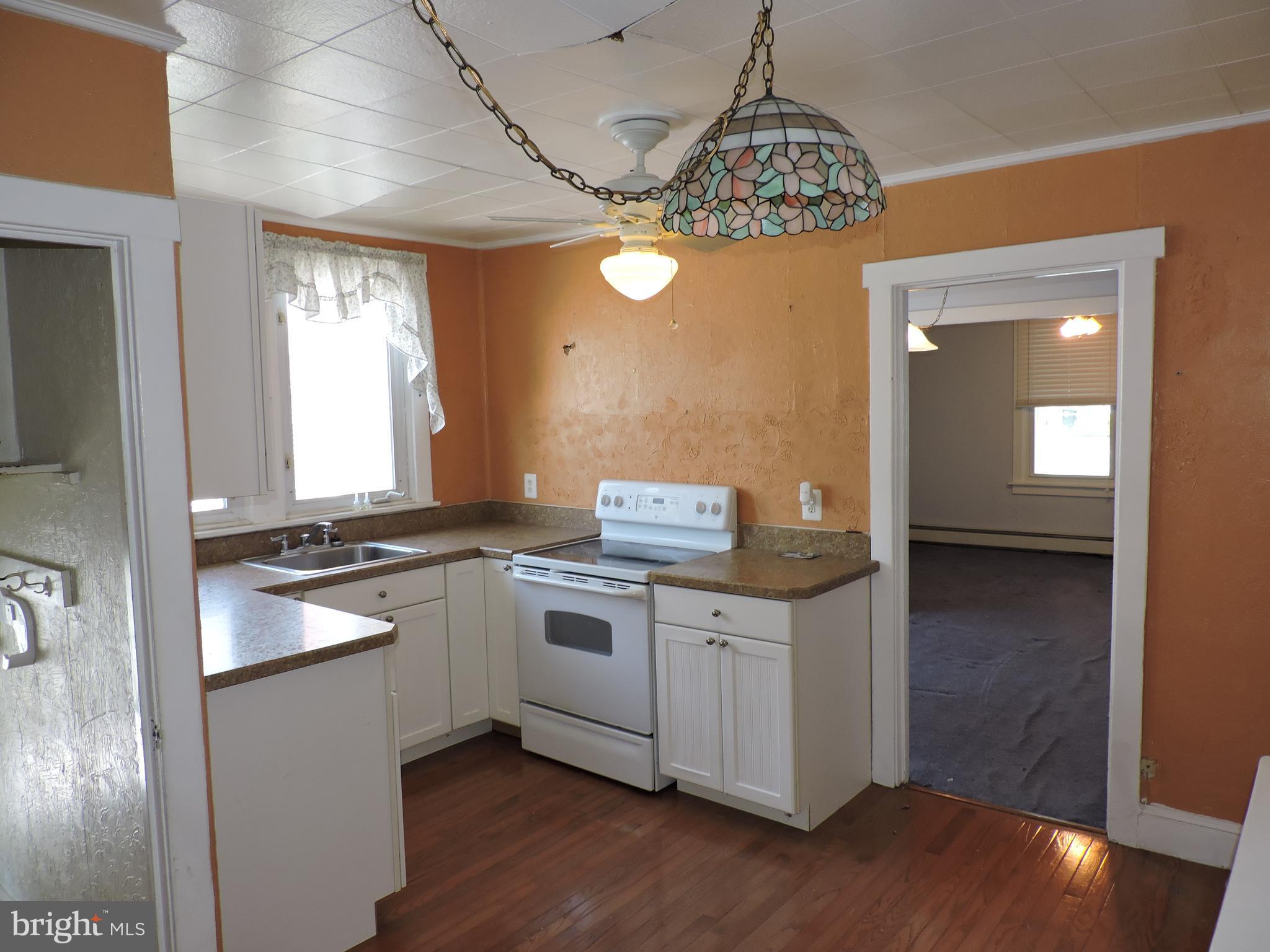 1116 Maple Street Conshohocken, PA 19428 - Photo 12 of 42 a kitchen with stainless steel appliances granite countertop a stove a sink dishwasher and a refrigerator with wooden floor