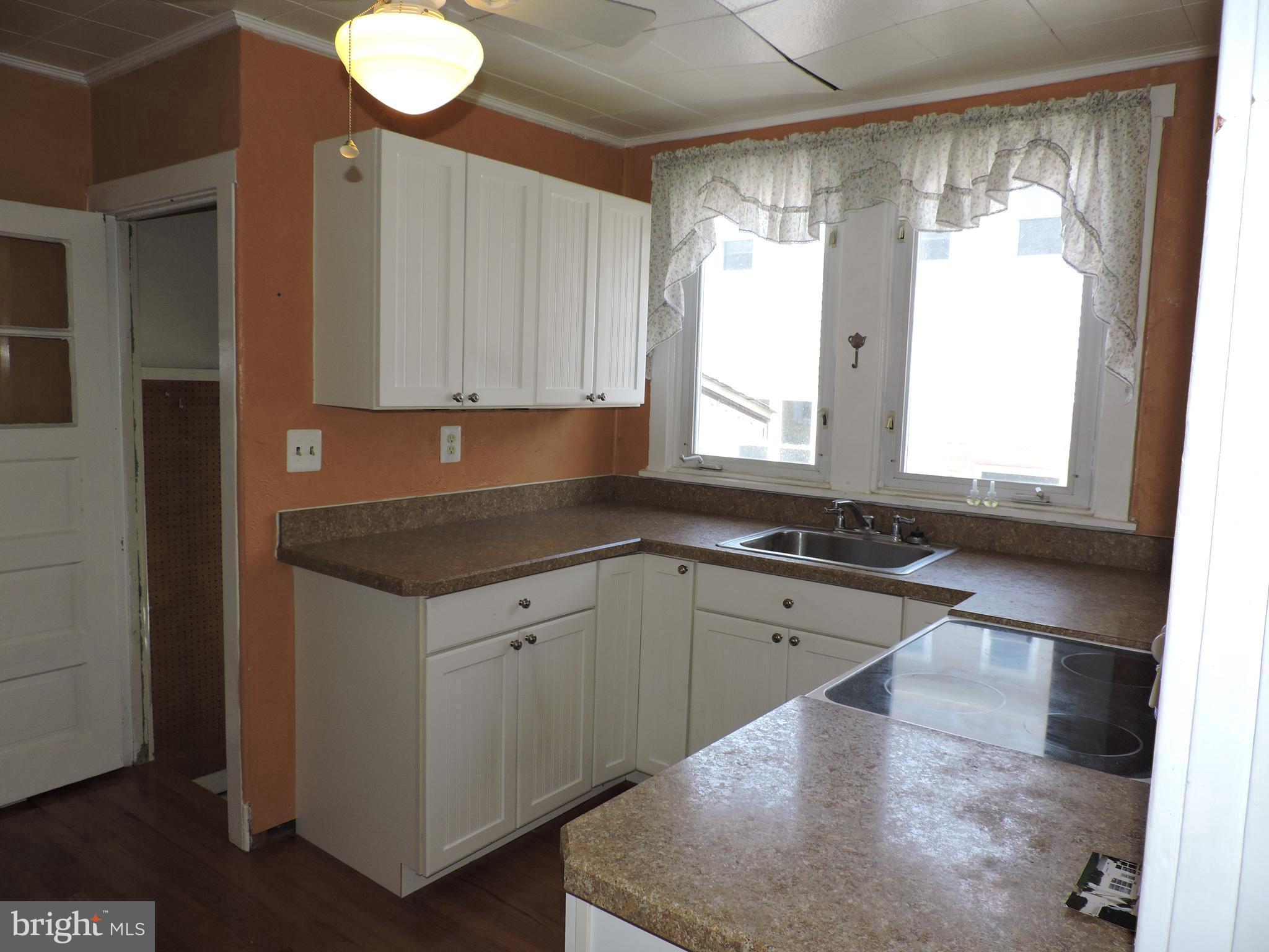 1116 Maple Street Conshohocken, PA 19428 - Photo 21 of 42 a kitchen with granite countertop a sink window and cabinets
