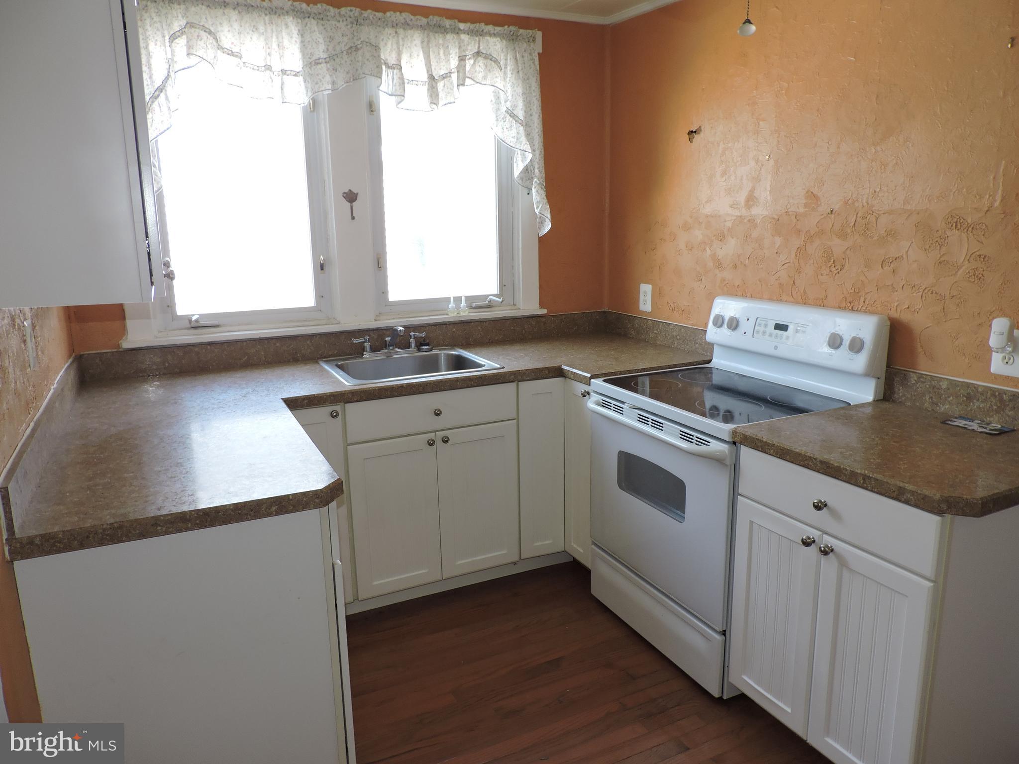 1116 Maple Street Conshohocken, PA 19428 - Photo 23 of 42 a kitchen with a sink stove and cabinets