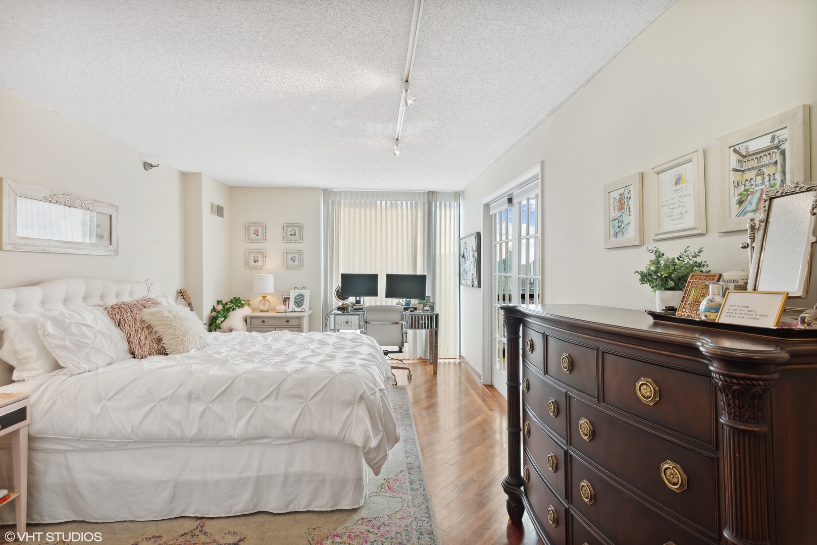 1122 North Clark Street, Unit 3401 Chicago, IL 60610 - Photo 13 of 26 a bedroom with a bed and a dresser