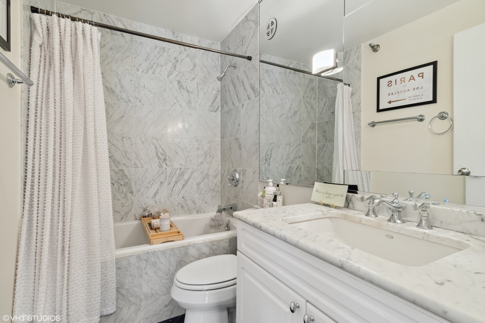 1122 North Clark Street, Unit 3401 Chicago, IL 60610 - Photo 14 of 26 a bathroom with a granite countertop sink a toilet and a mirror