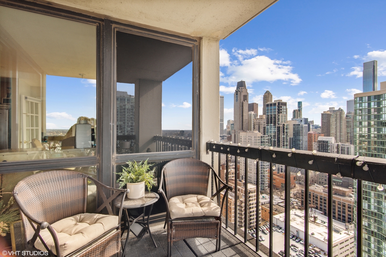 1122 North Clark Street, Unit 3401 Chicago, IL 60610 - Photo 17 of 26 a view of a balcony with chair and a potted plant