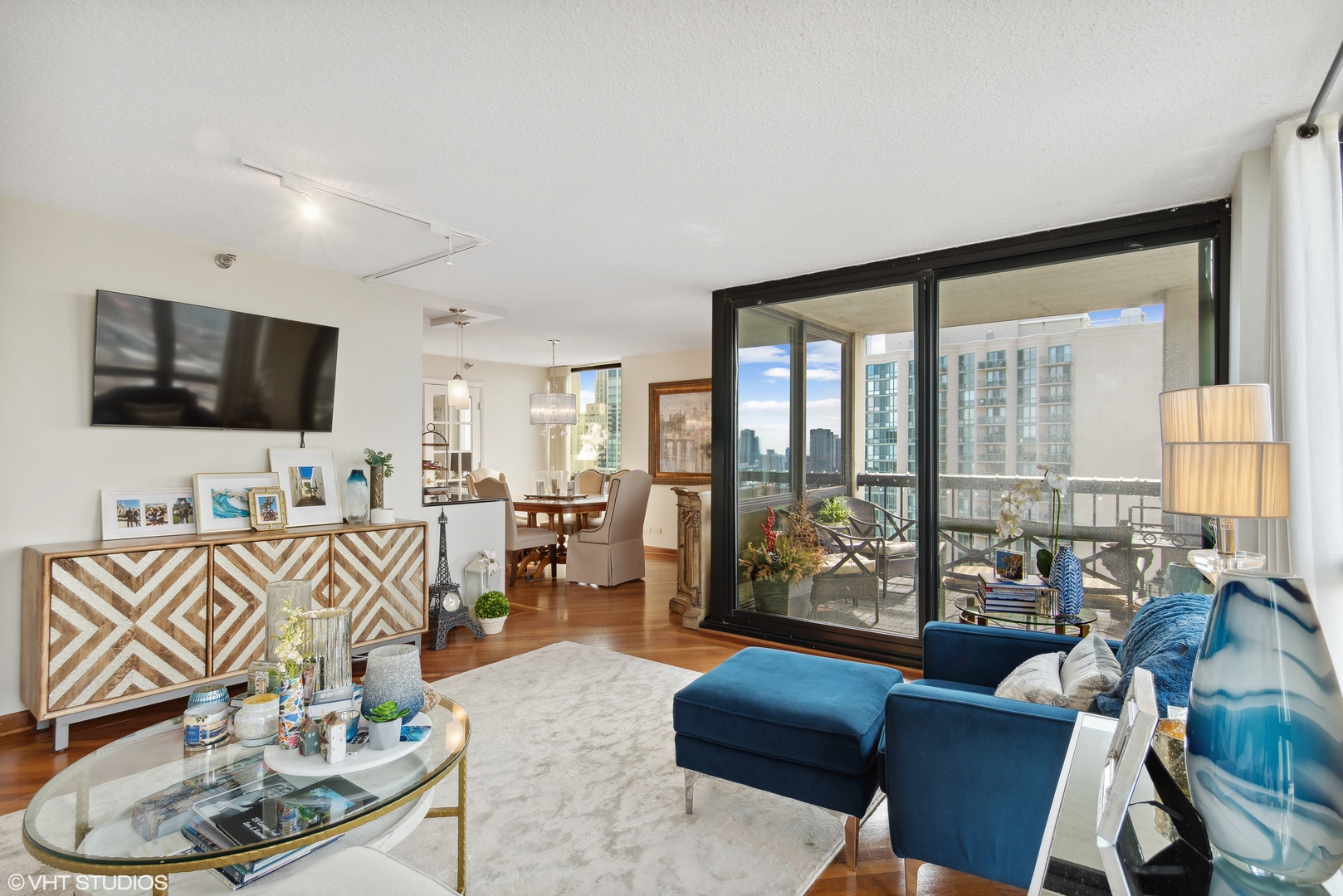 1122 North Clark Street, Unit 3401 Chicago, IL 60610 - Photo 5 of 26 a living room with furniture and a flat screen tv