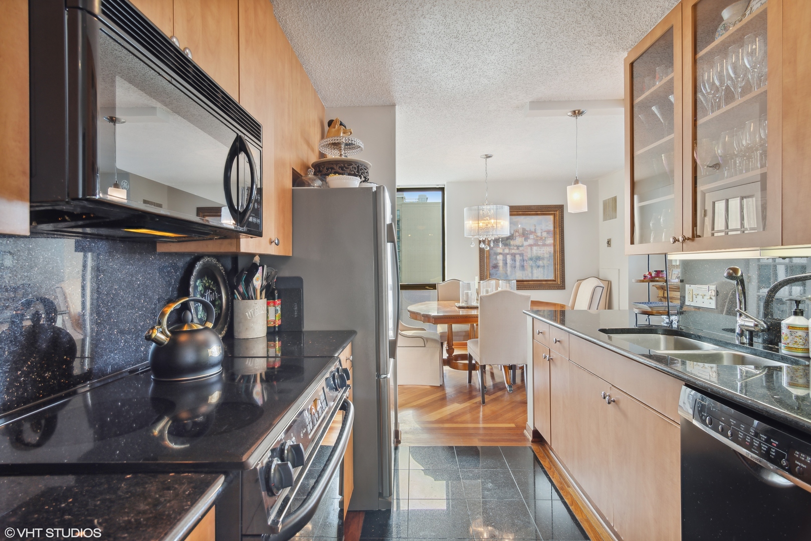 1122 North Clark Street, Unit 3401 Chicago, IL 60610 - Photo 6 of 26 a kitchen with stainless steel appliances granite countertop a sink stove and cabinets