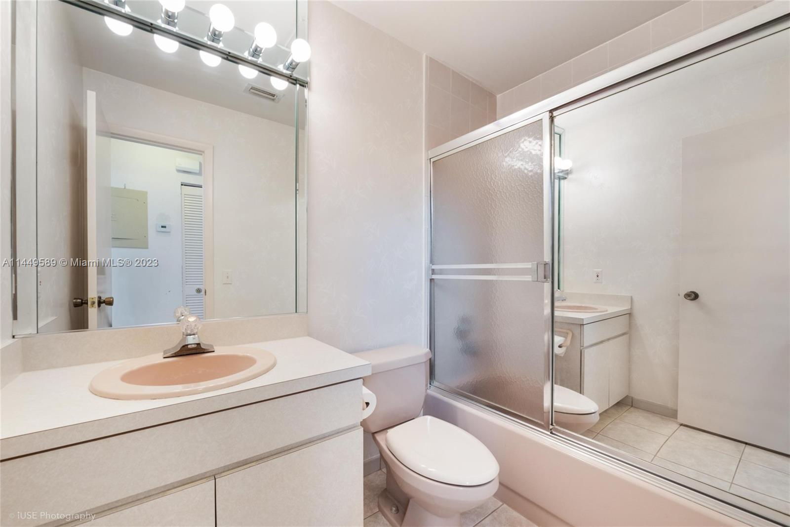 9208 Southwest 132nd Street Miami, FL 33176 - Photo 11 of 15 a bathroom with a sink a toilet and shower a mirror