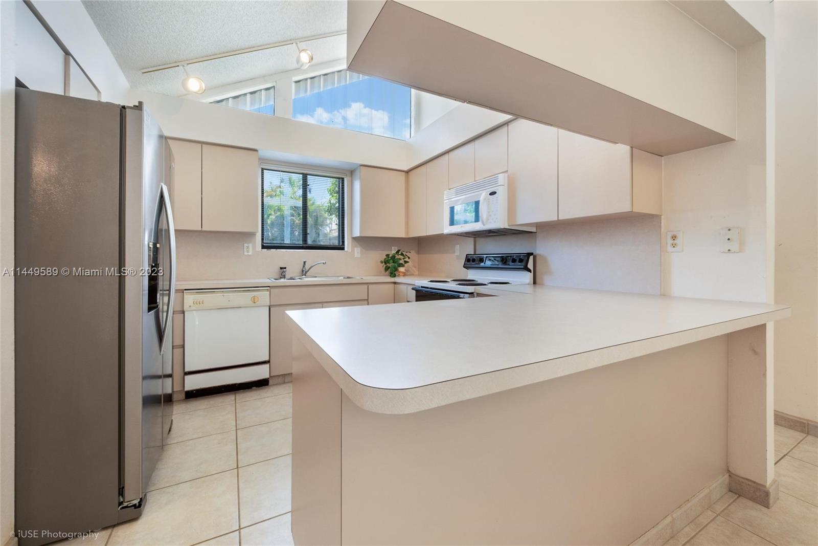 9208 Southwest 132nd Street Miami, FL 33176 - Photo 2 of 15 a kitchen with stainless steel appliances a refrigerator sink and cabinets