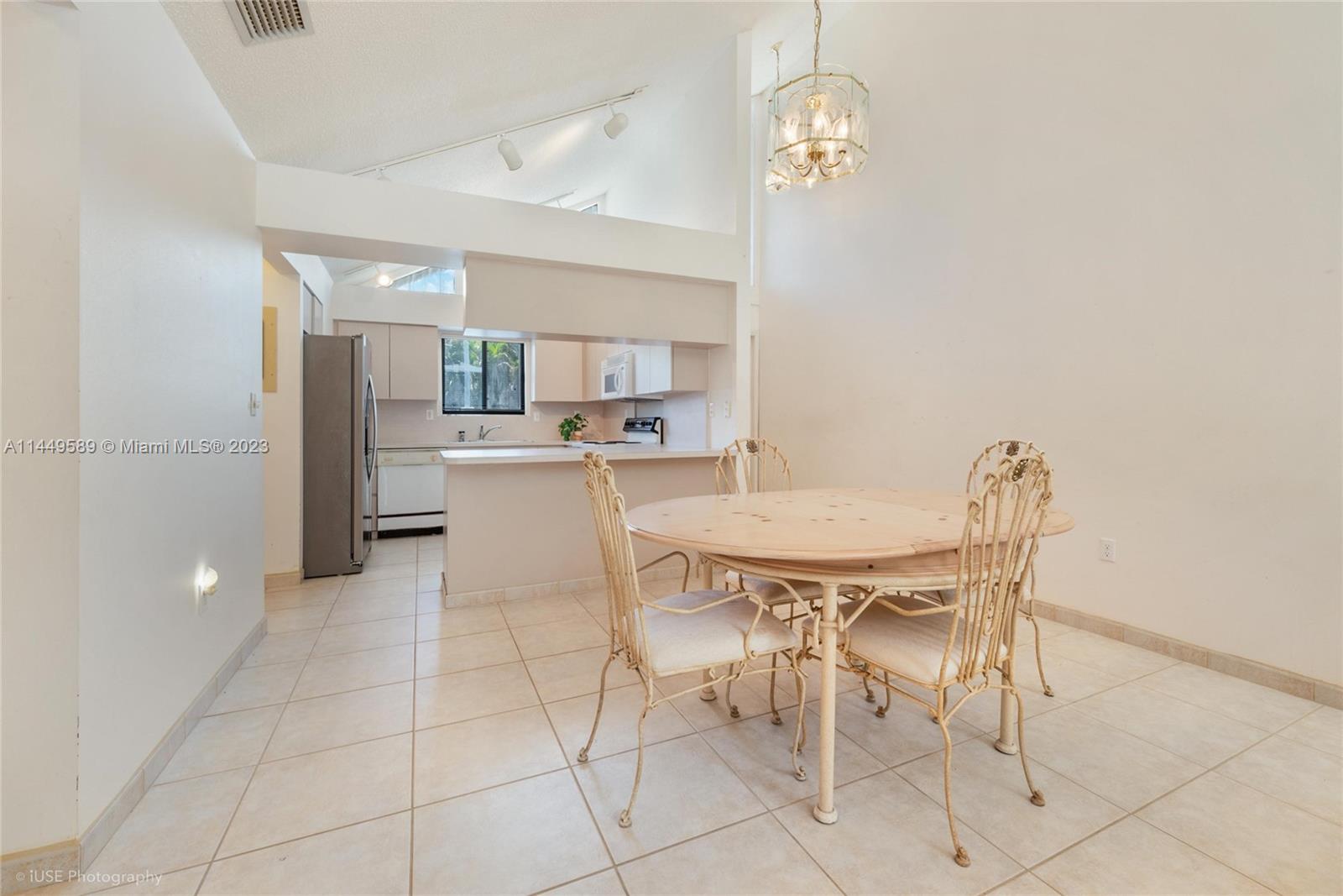 9208 Southwest 132nd Street Miami, FL 33176 - Photo 4 of 15 a view of a dining room with furniture and a chandelier
