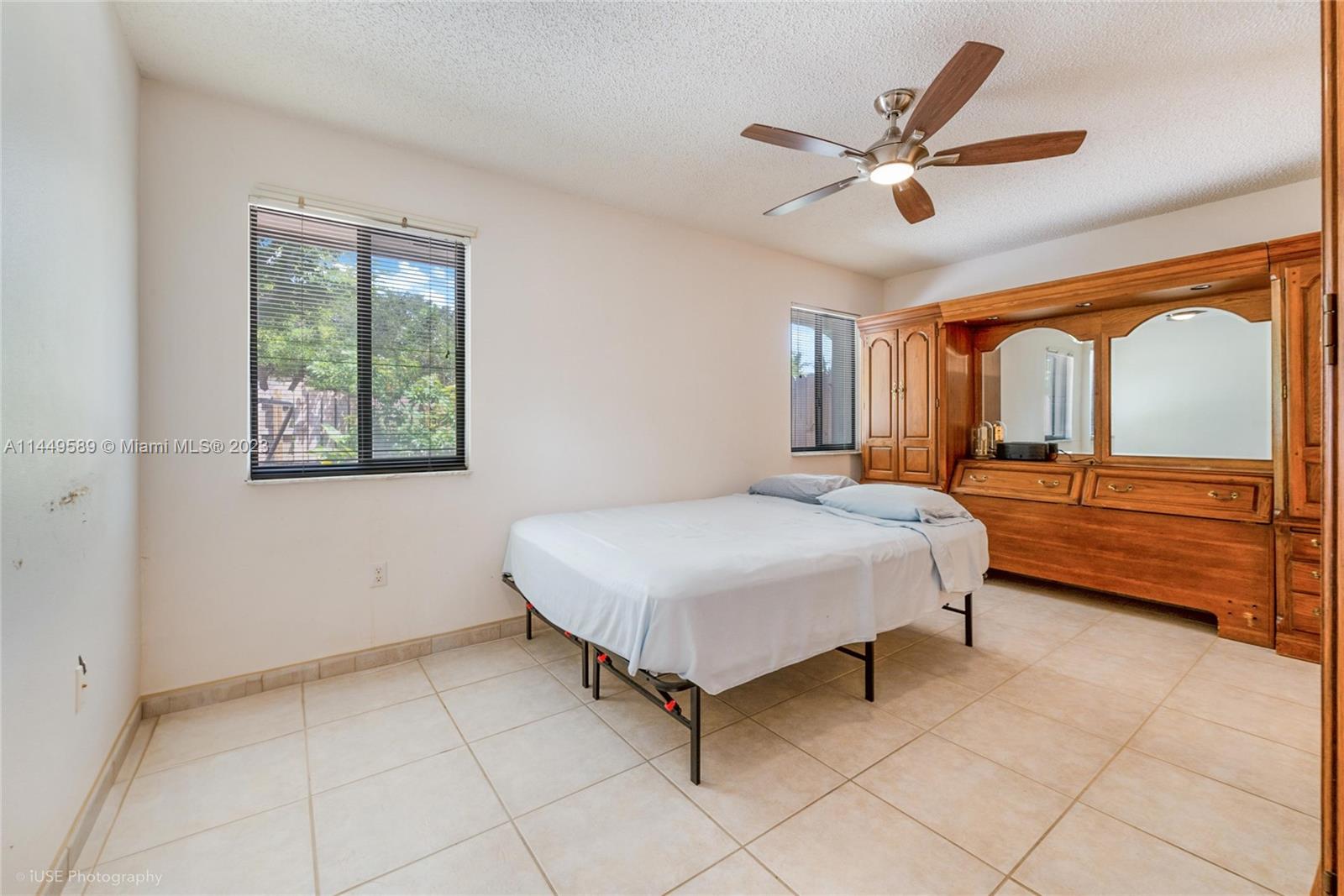 9208 Southwest 132nd Street Miami, FL 33176 - Photo 6 of 15 a bedroom with a large bed and a large window