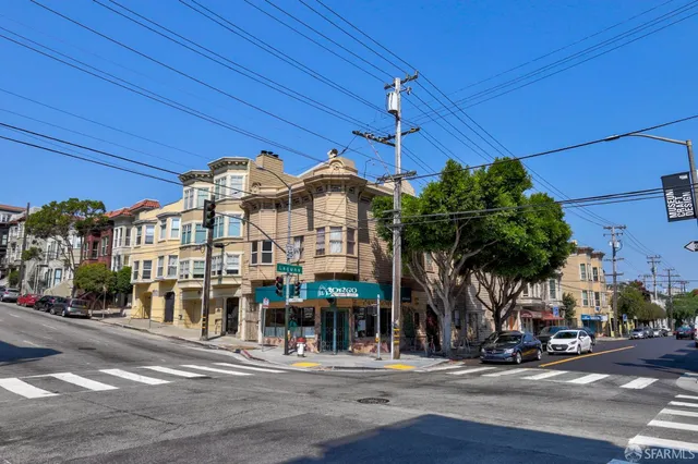 a front view of a building with streets and trees
