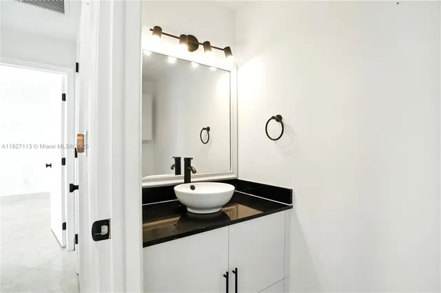 a bathroom with a sink and mirror