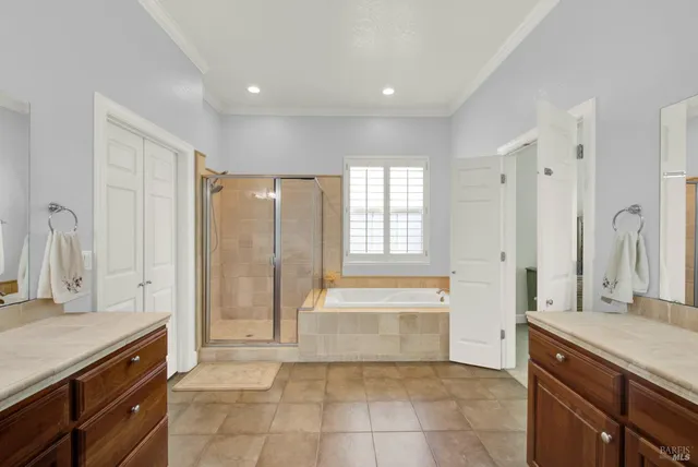 an aerial view of residential houses with outdoor space and parking