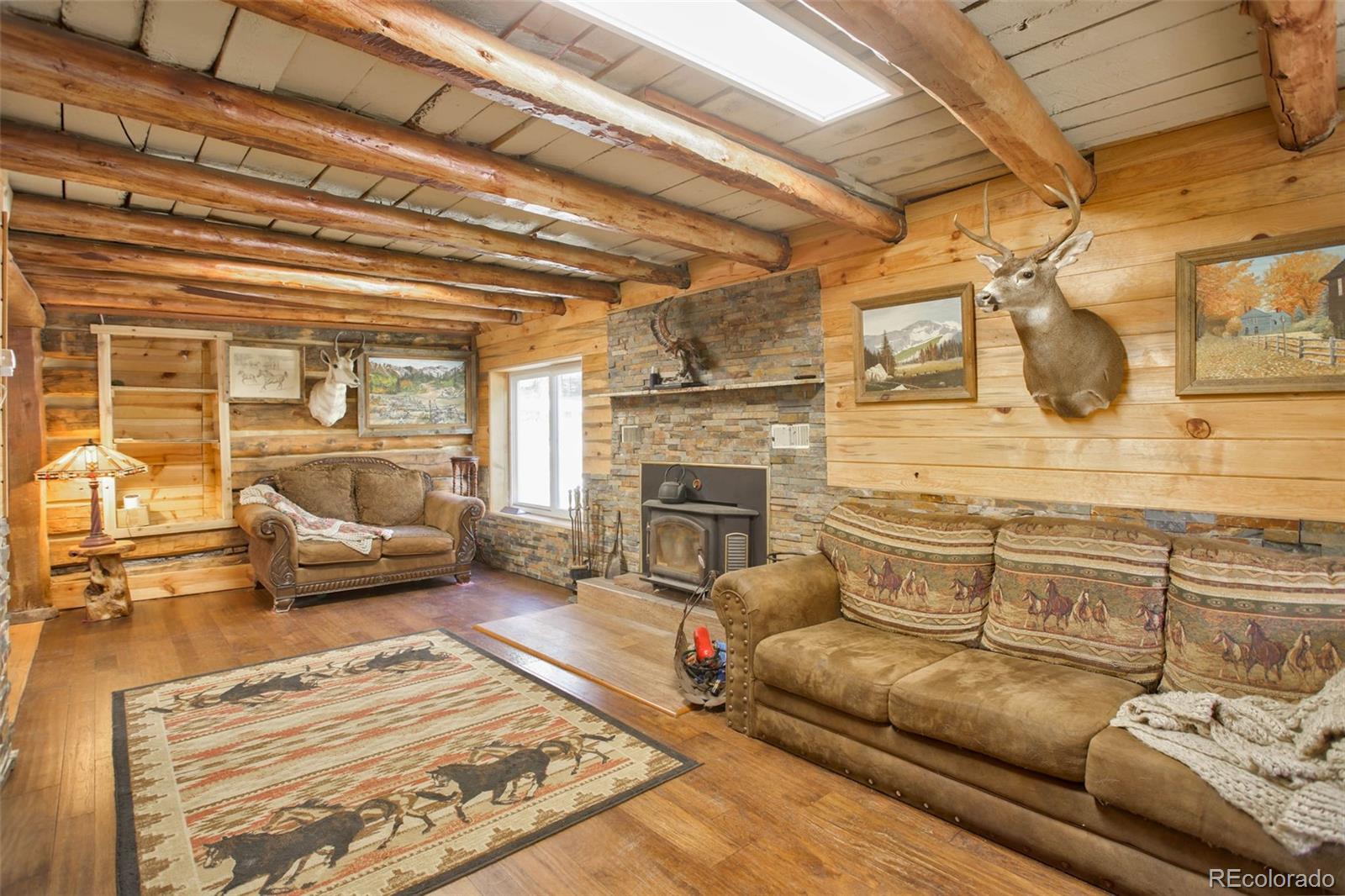9399 Granzella Road Morrison, CO 80465 - Photo 11 of 41 a living room with furniture and a fireplace
