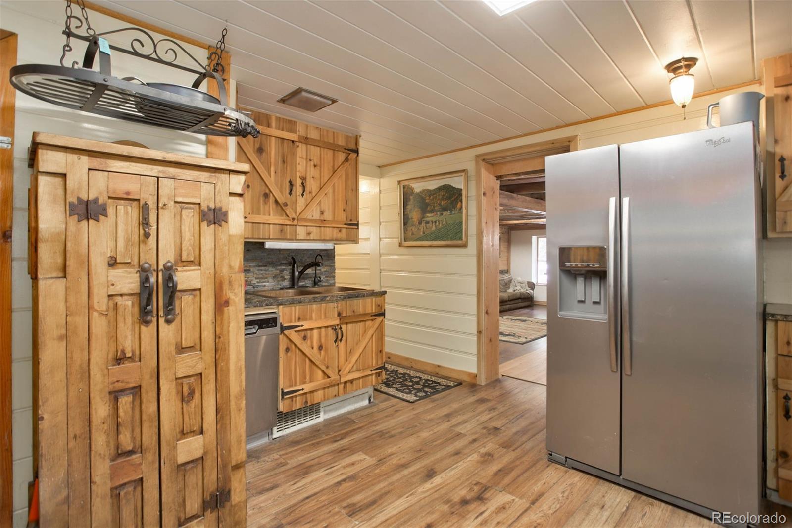 9399 Granzella Road Morrison, CO 80465 - Photo 15 of 41 a kitchen with stainless steel appliances granite countertop a refrigerator and a stove top oven