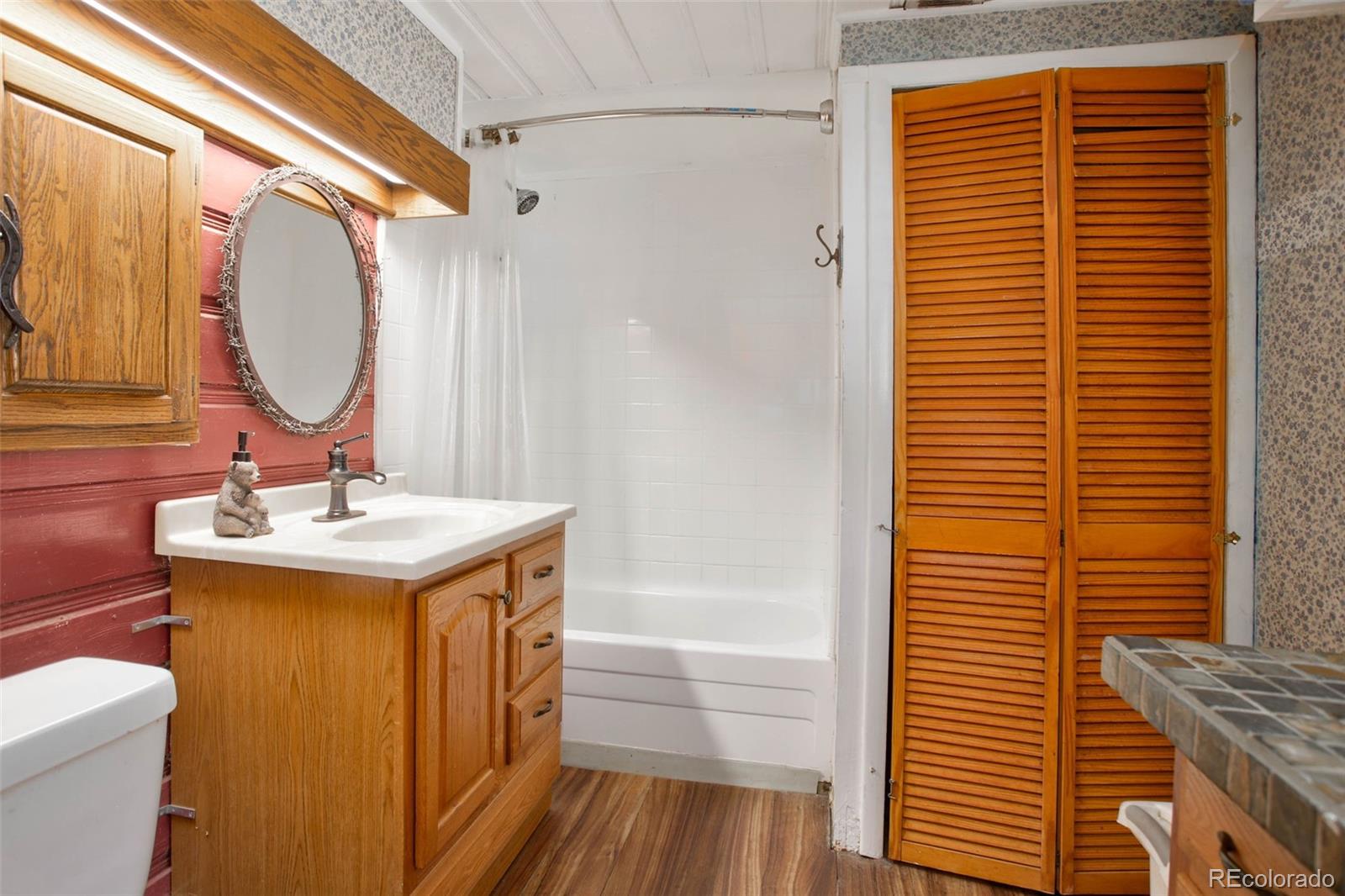 9399 Granzella Road Morrison, CO 80465 - Photo 19 of 41 a bathroom with a sink a mirror and a shower