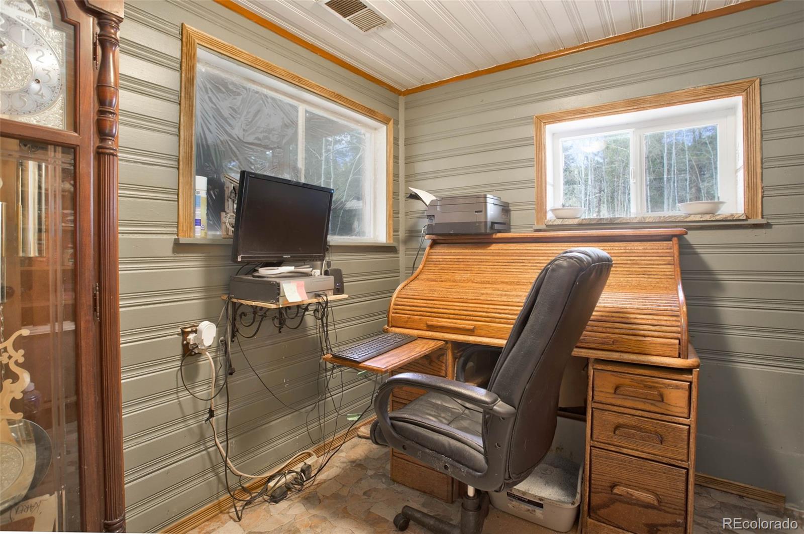 9399 Granzella Road Morrison, CO 80465 - Photo 22 of 41 a view of workspace with wooden floor and windows