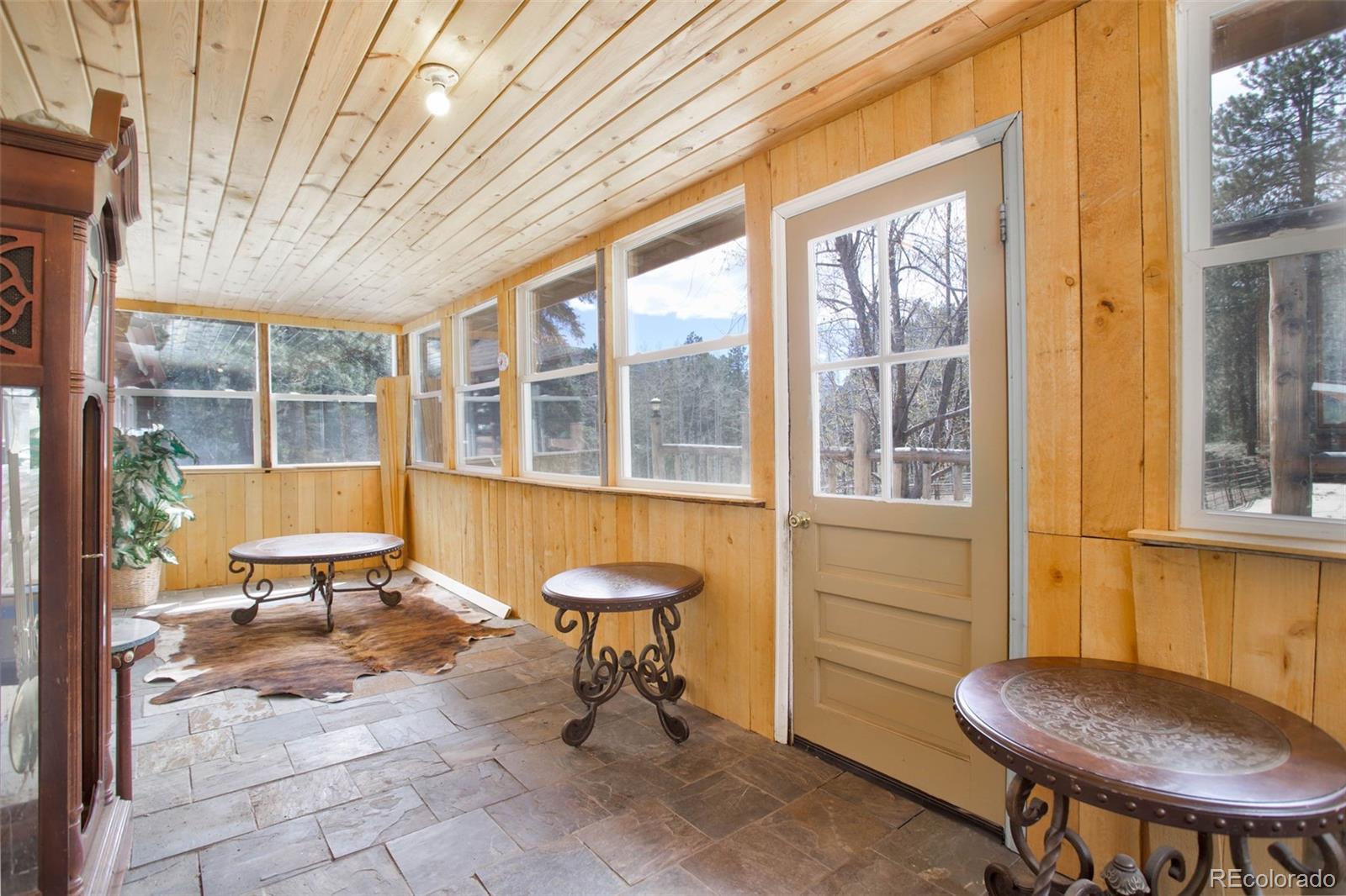9399 Granzella Road Morrison, CO 80465 - Photo 23 of 41 a building outdoor space with patio furniture and potted plants